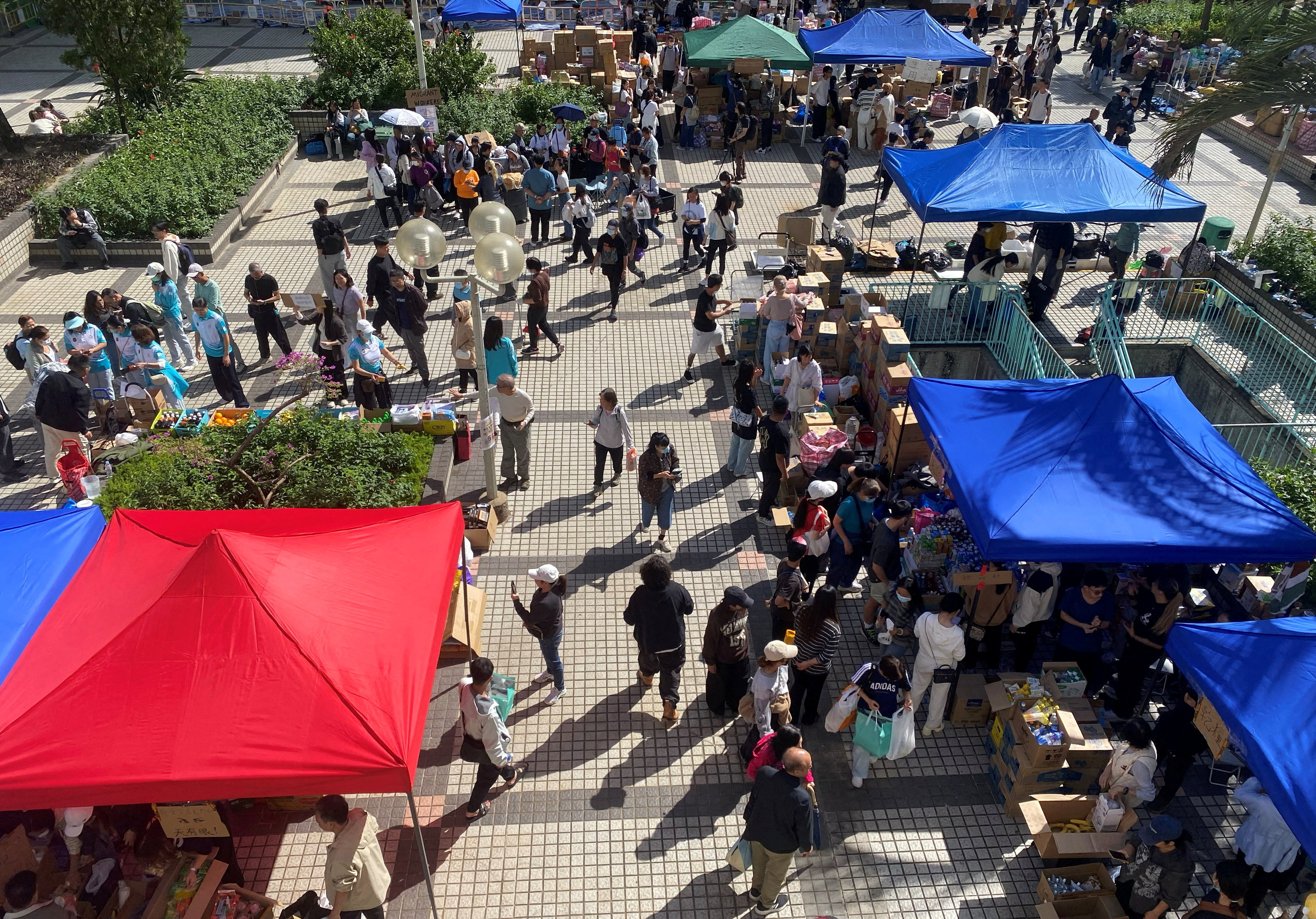 People visit a resource collection point set up by volunteers to provide supplies for residents impacted by the deadly fire, near the Wang Fuk Court housing complex in Tai Po, Hong Kong, China November 28, 2025. REUTERS/Jessie Pang