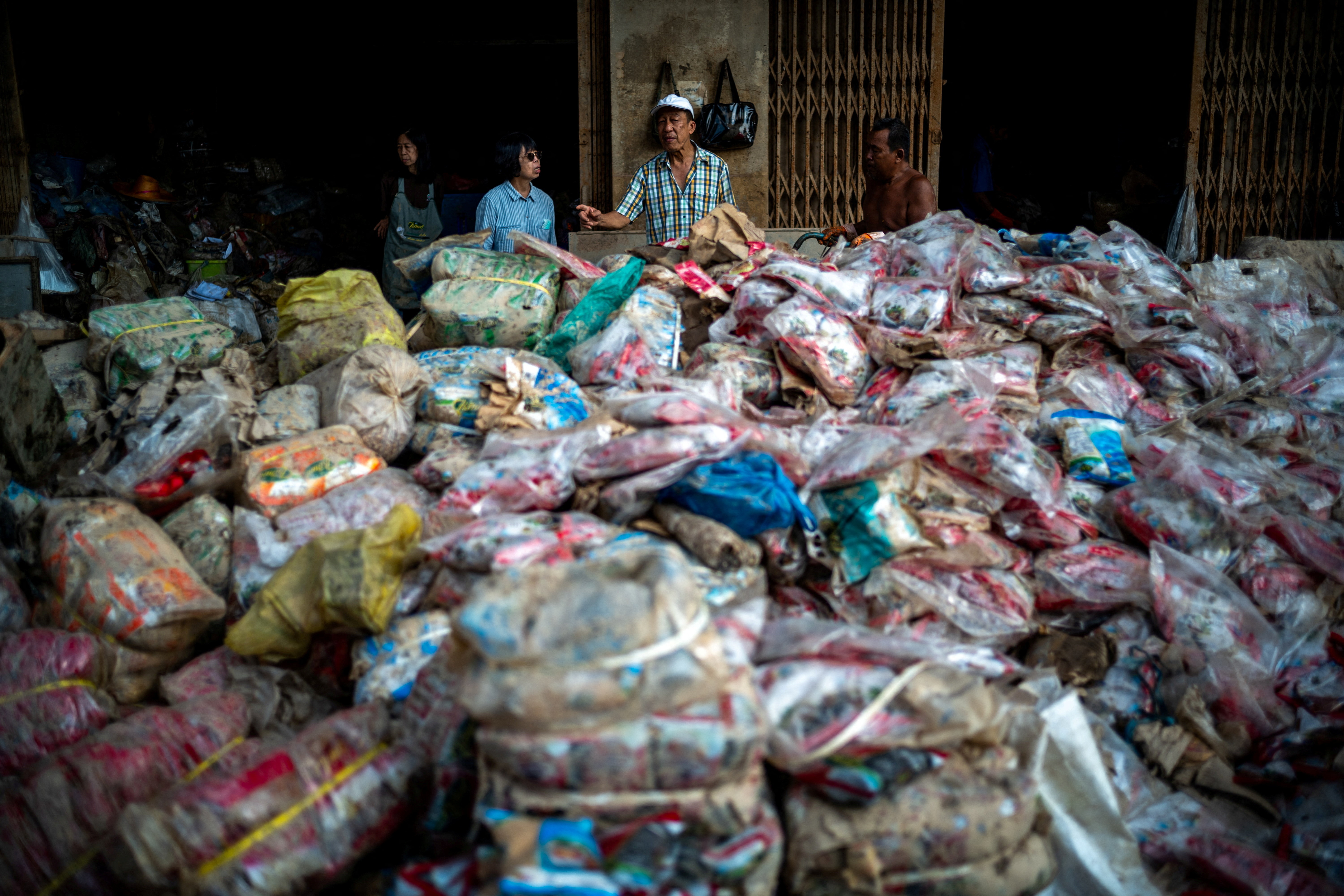 Shop owners stand next to their flood-damaged products following deadly flooding in Hat Yai district, Songkhla province, Thailand, November 30, 2025.