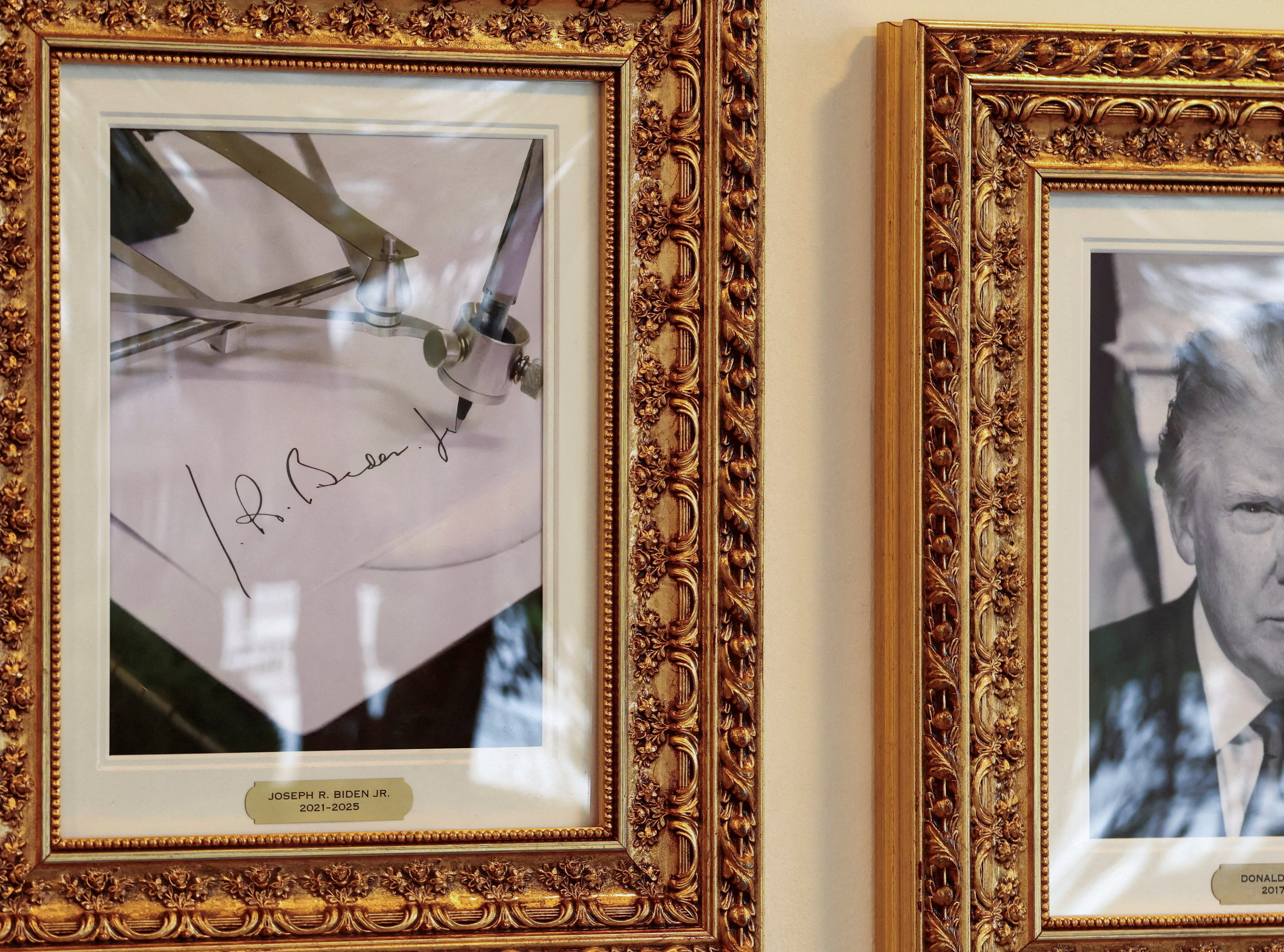 An image of an autopen writing former US President Joe Biden&#039;s signature is displayed next to a portrait of US President Donald Trump at the Presidential Walk of Fame in the White House in Washington, DC, on September 25, 2025 [Kevin Lamarque/Reuters]