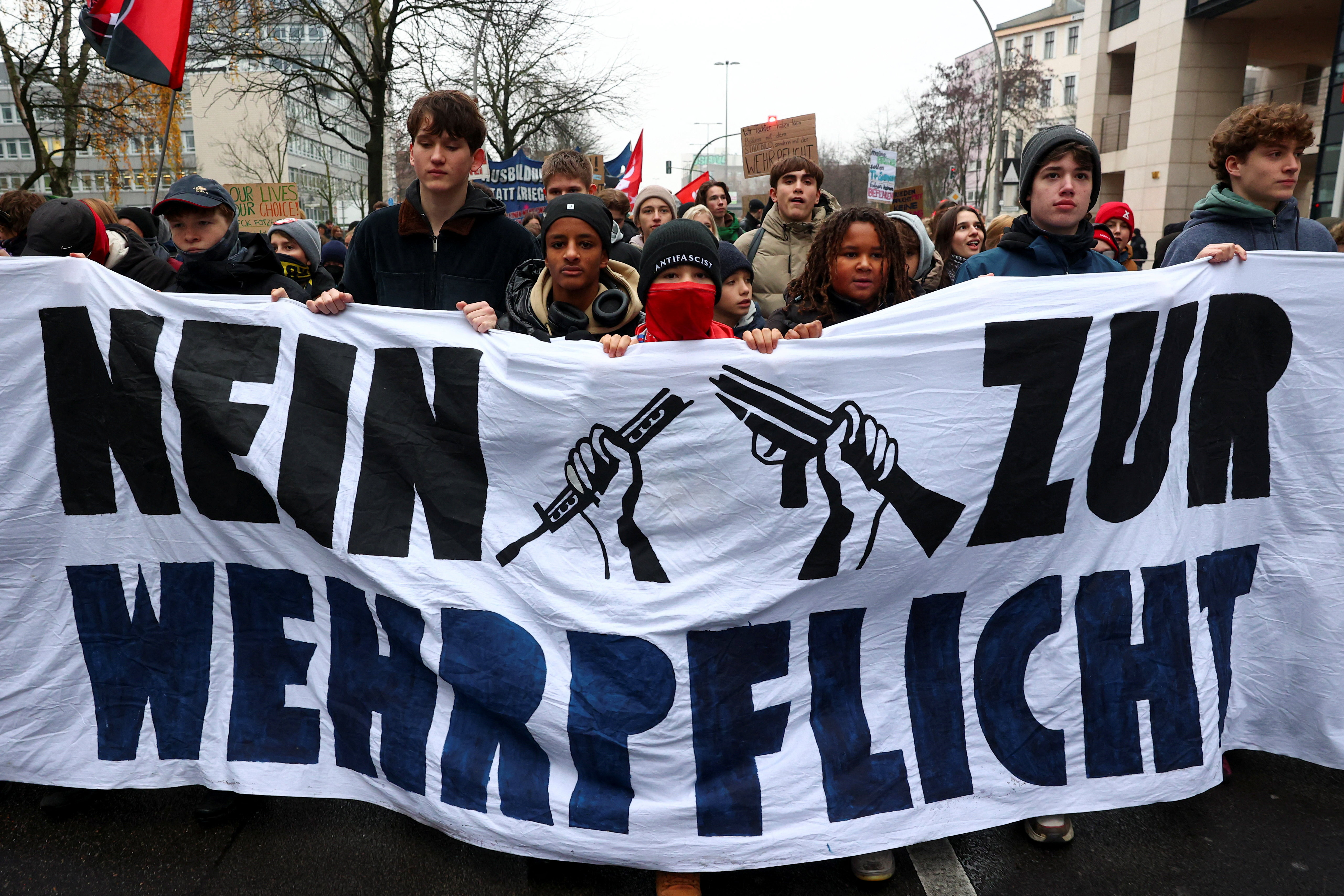 People hold a banner reading "No to compulsory military service", during a protest against compulsory military service in Berlin, Germany December 5, 2025. REUTERS/Christian Mang