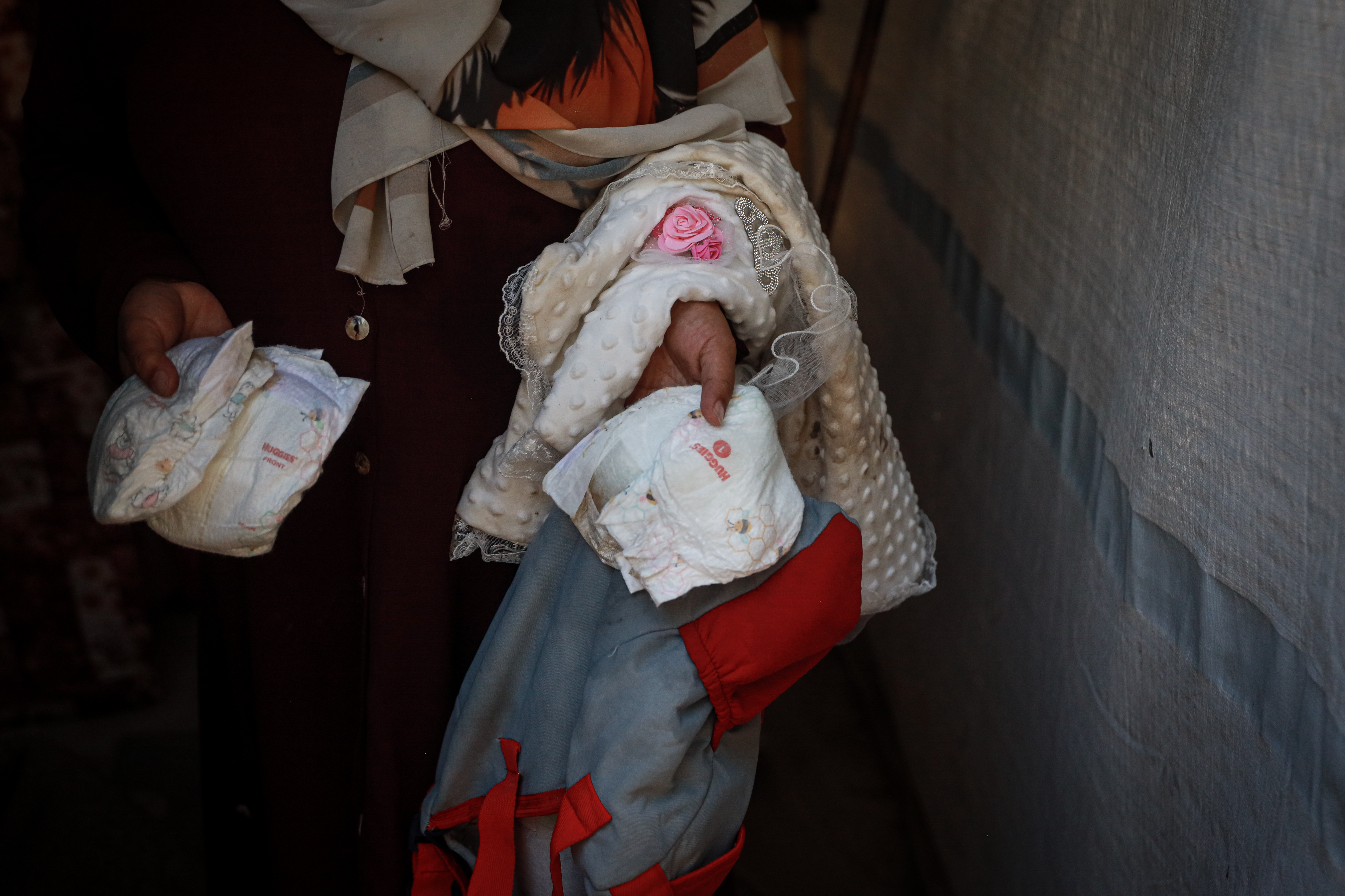 Close up of a woman holding nappies damaged by water
