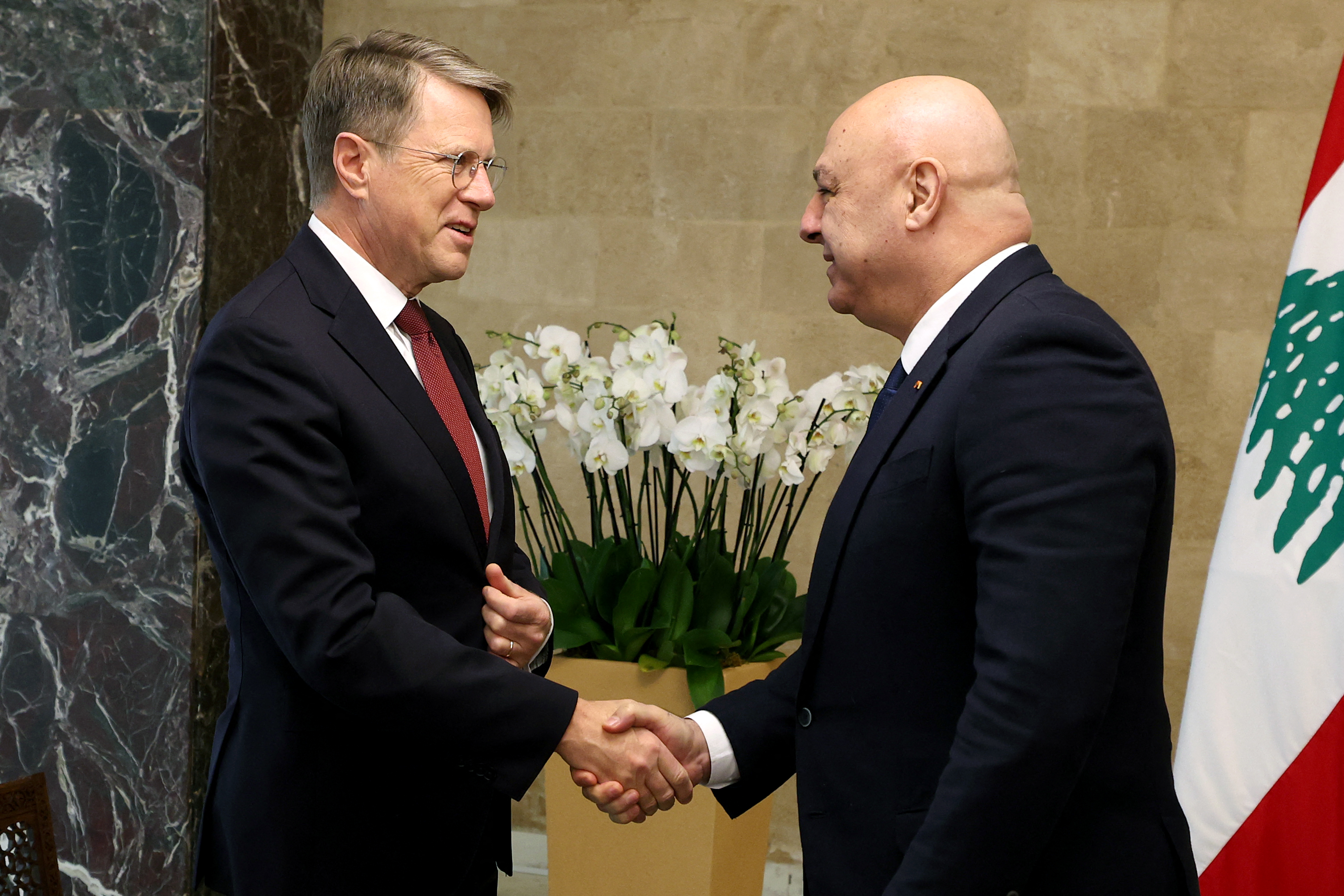 Lebanese President Joseph Aoun (R) greeting Slovenia's UN Ambassador Samuel Zbogar.