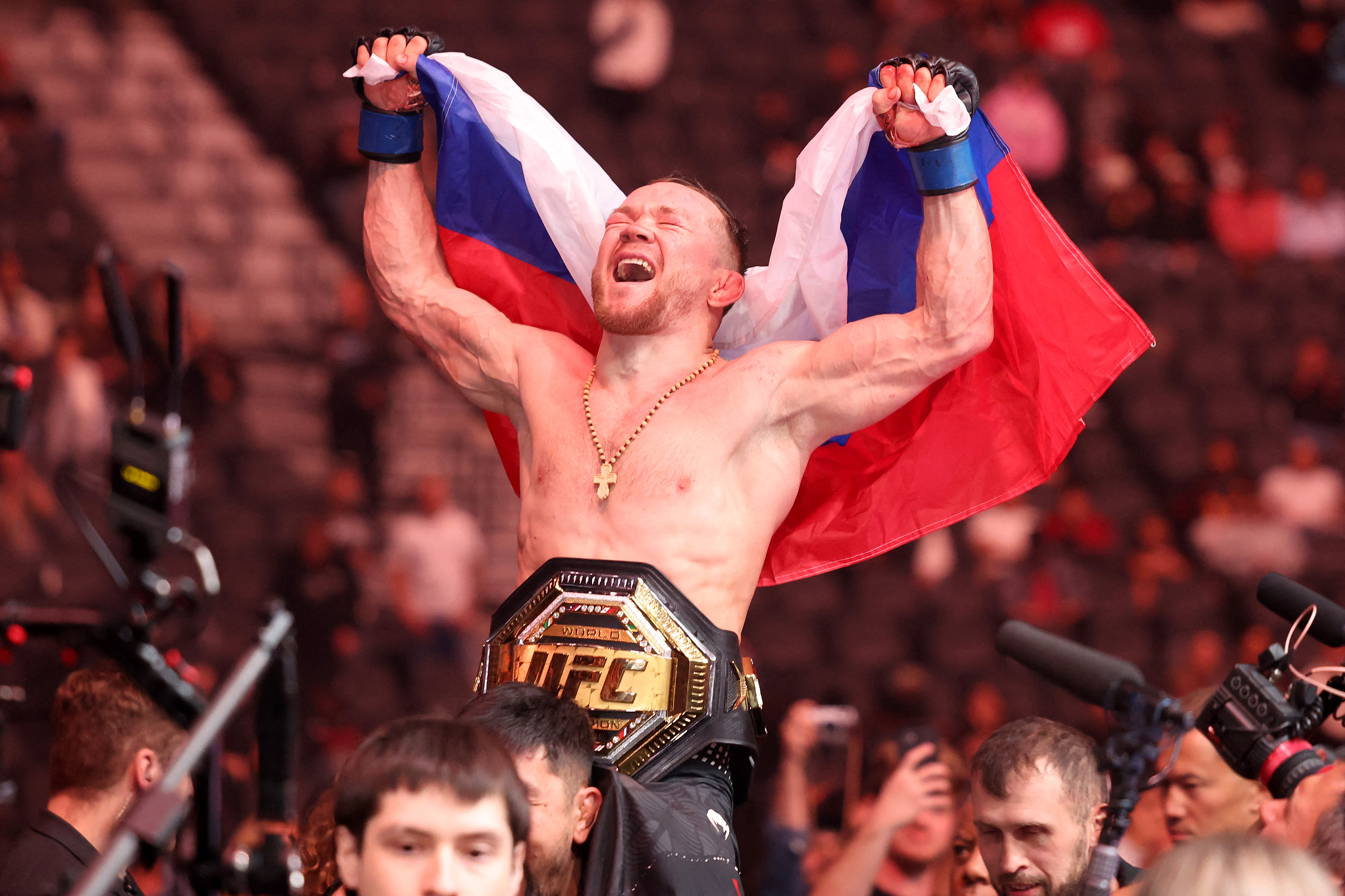 Petr Yan celebrates with a Russian flag.
