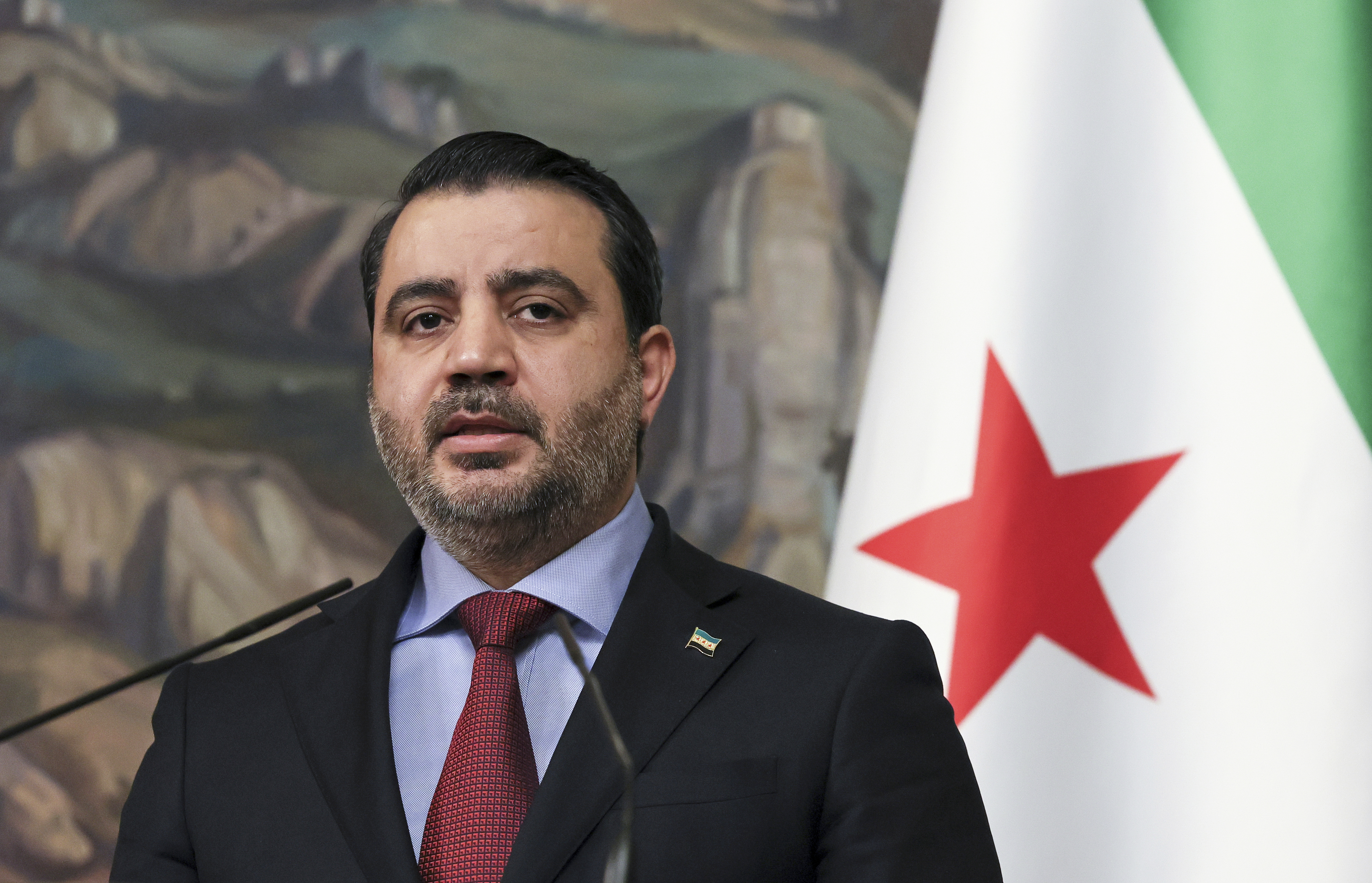 Syrian Foreign Minister Asaad al-Shaibani speaks to the press.
