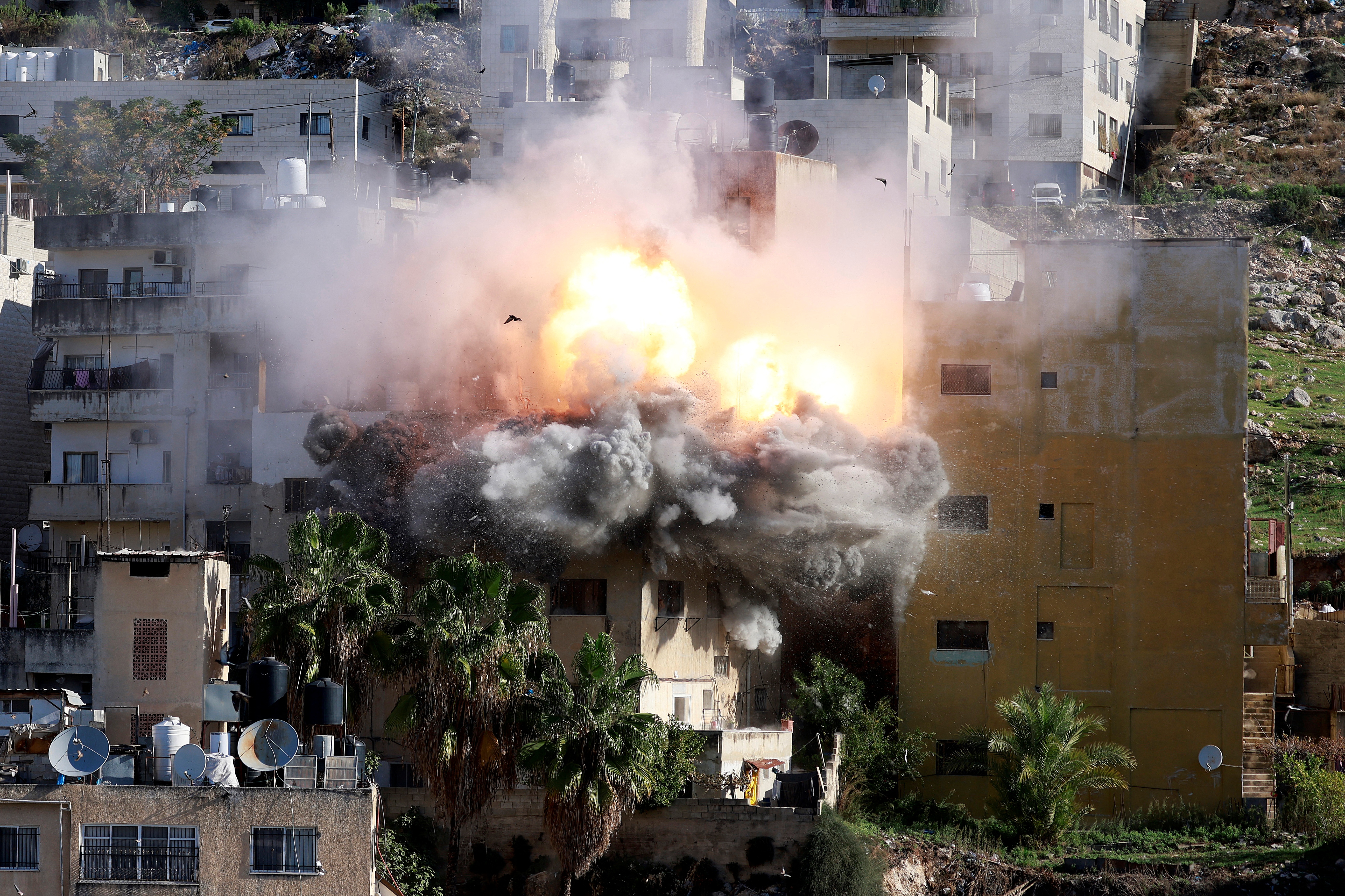 Smoke billows as Israeli forces demolish the house of Abdul Karim Snobar, who was detained by Israel earlier this year after being accused of plotting bus bombings, in the occupied West Bank city of Nablus on December 2, 2025. (Photo by Jaafar ASHTIYEH / AFP)
