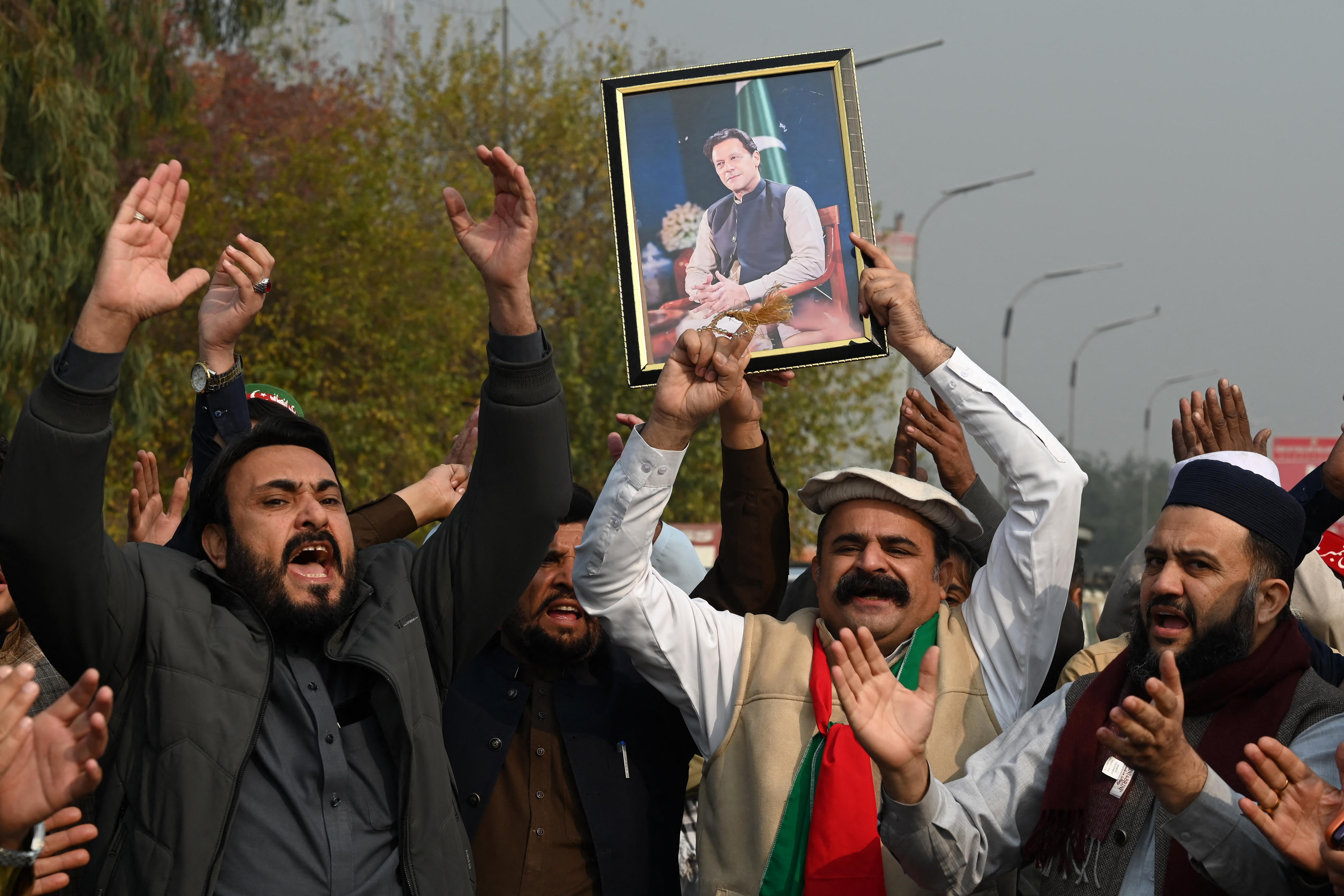 Pakistan Tehreek-e-Insaf (PTI) party supporters protest to demand release of their jailed leader and Pakistan's former Prime Minister Imran Khan, in Peshawar on December 2, 2025.
