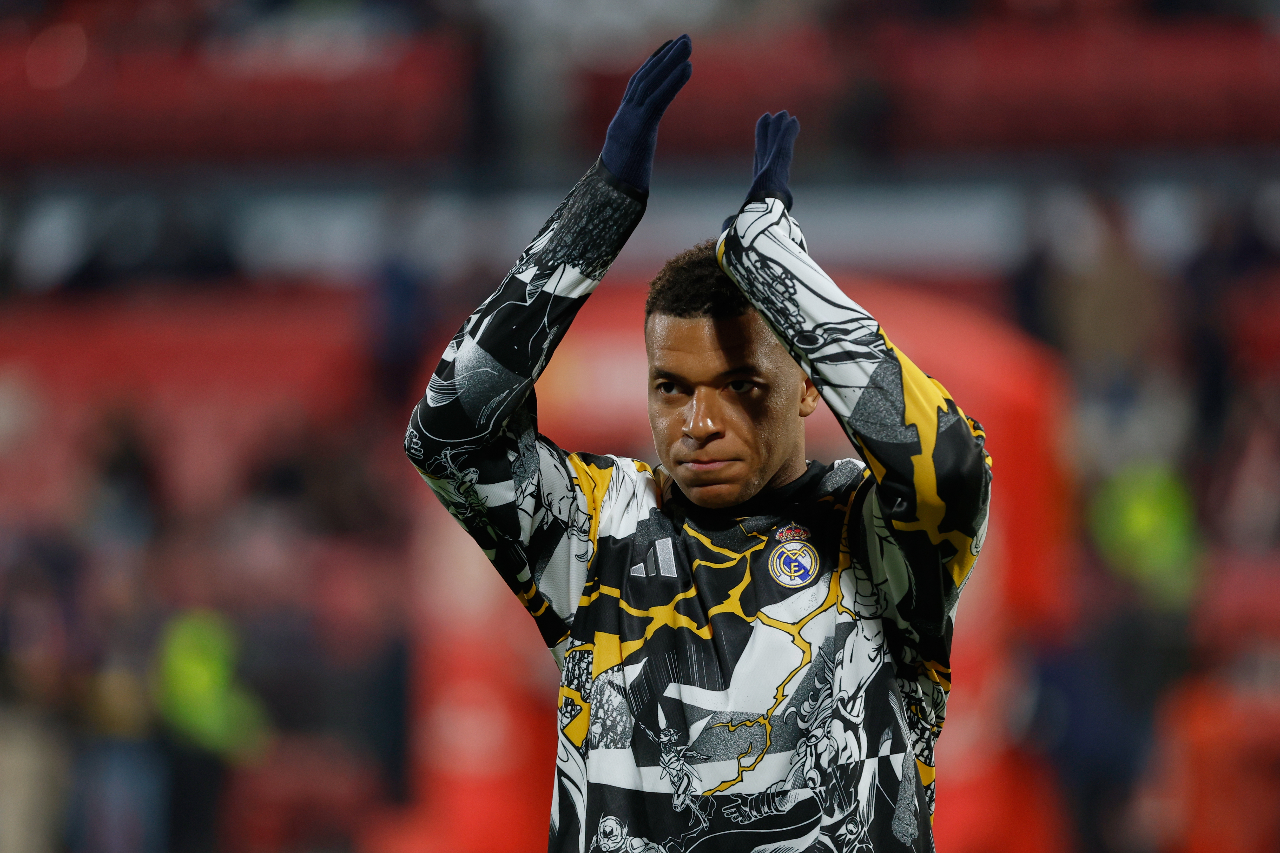 Real Madrid's Kylian Mbappe applauds prior the start the Spanish La Liga soccer match between Girona and Real Madrid, in Girona, Spain, Sunday, Nov. 30, 2025. (AP Photo/Joan Monfort)