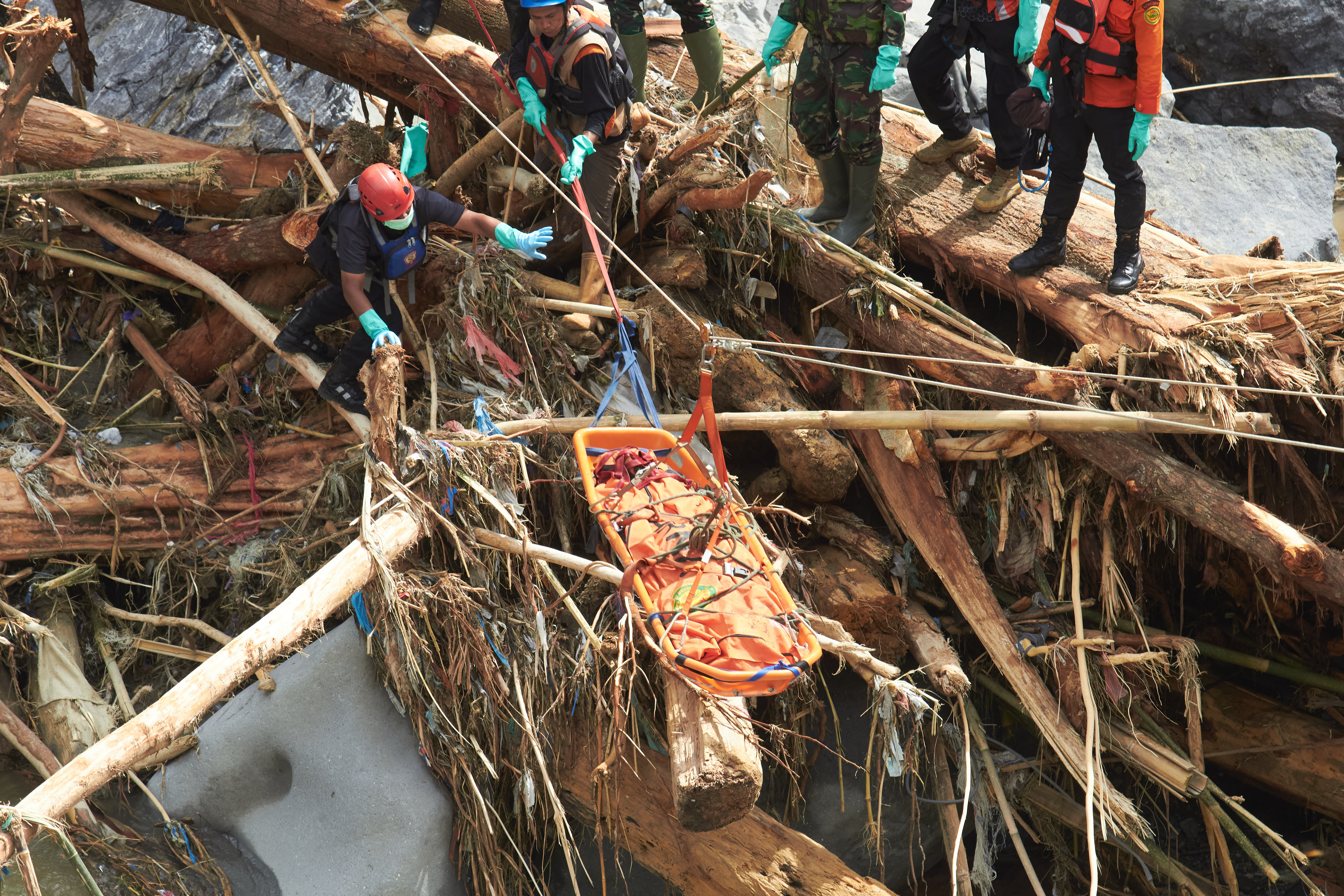 Rescuers use ropes to evacuate the body of a flood victim in Tanah Datar, West Sumatra, Indonesia, Monday, Dec. 1, 2025. (AP Photo/Nazar Chaniago)