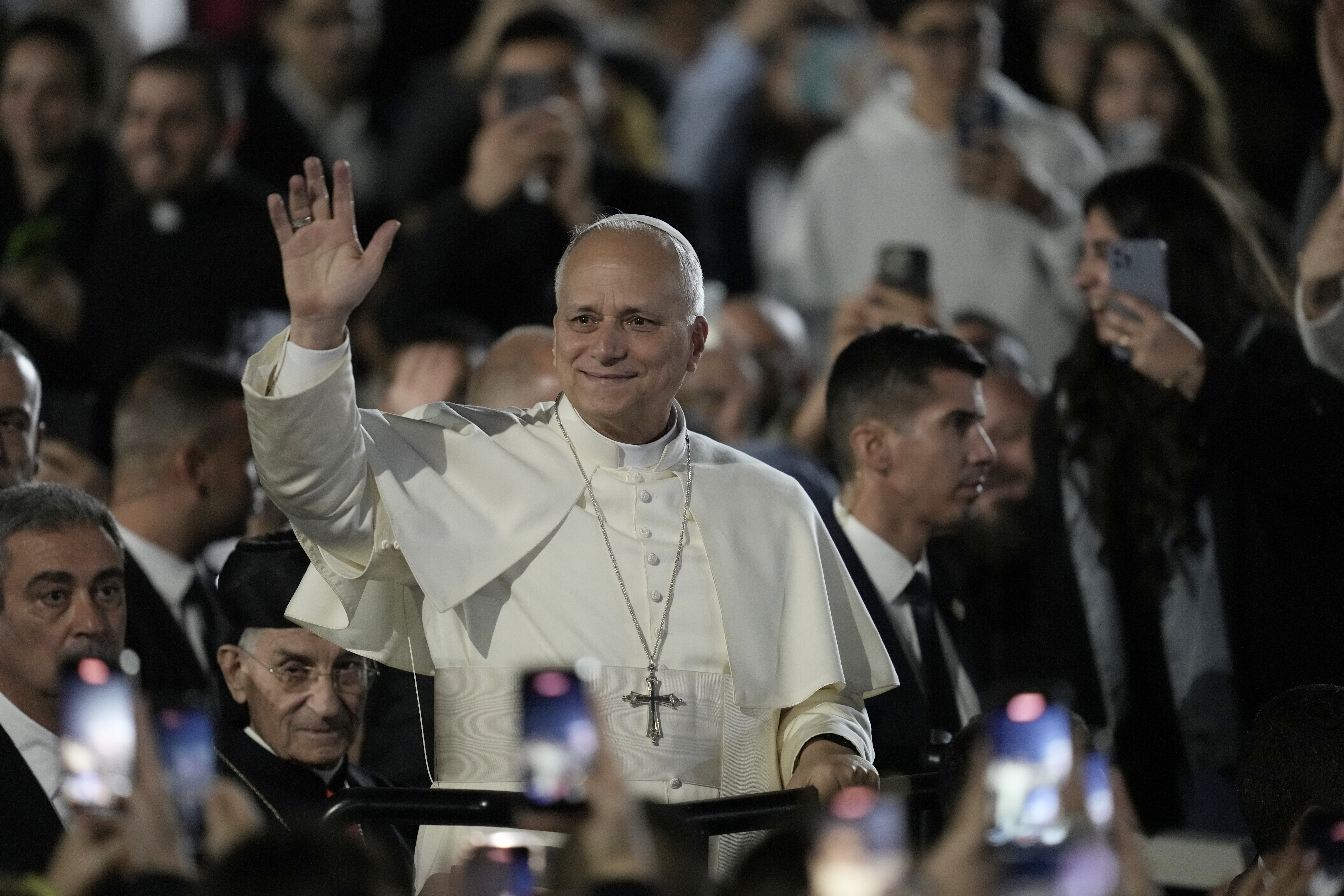 Pope Leo XIV waves as he arrives for a visit to Bkerki, the seat of the Maronite Church, in Lebanon, Monday, Dec. 1, 2025. (AP Photo/Bilal Hussein)