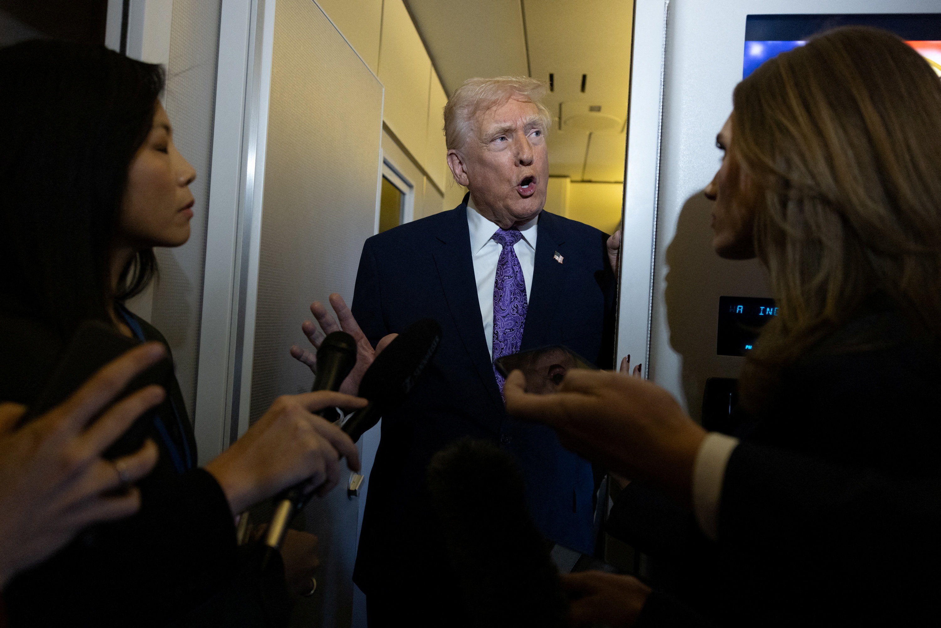 U.S. President Donald Trump speaks to reporters during travel to Washington, D.C., from Palm Beach International Airport, Florida, U.S., November 30, 2025. REUTERS/Anna Rose Layden