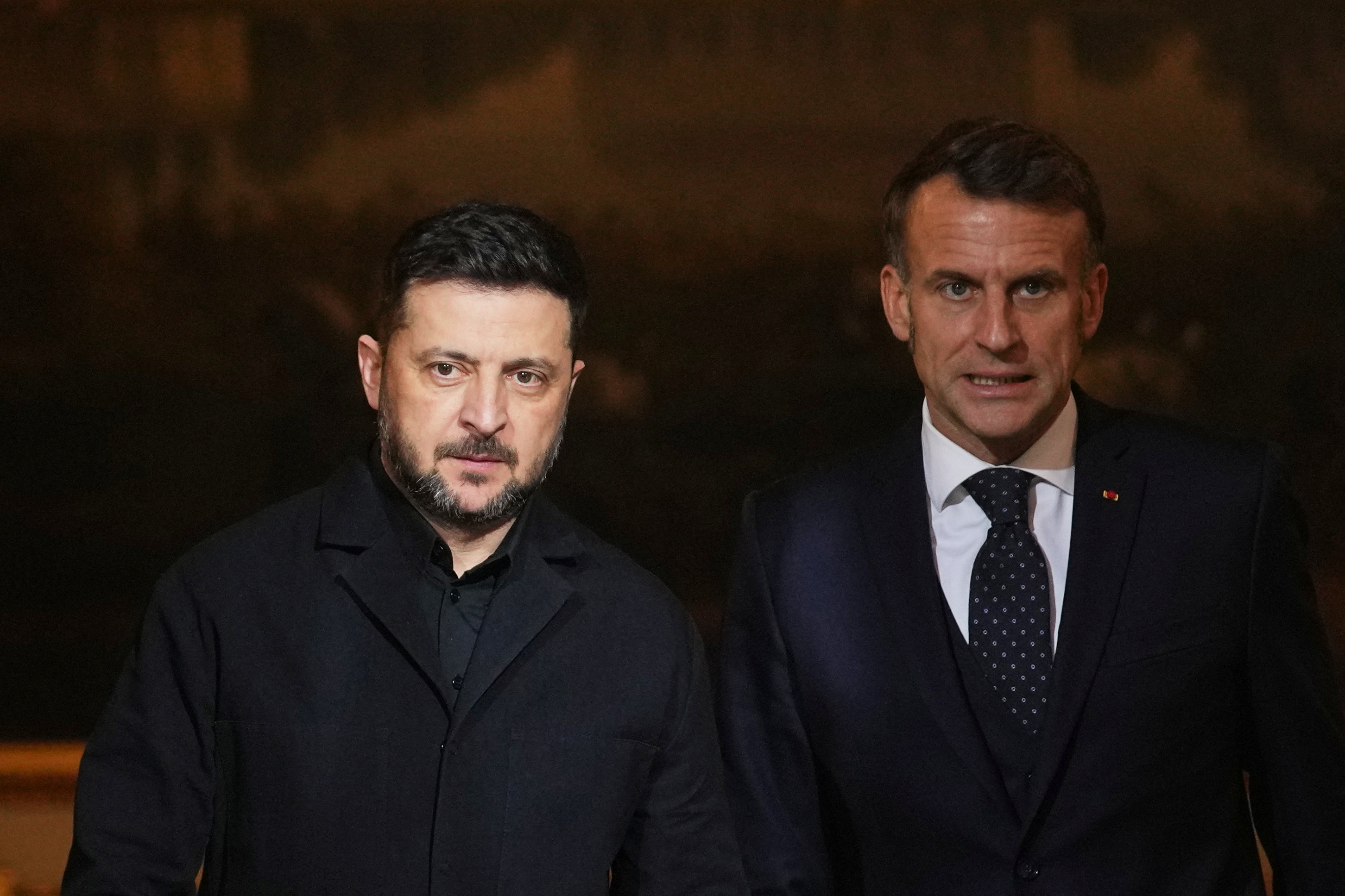 French President Emmanuel Macron, right, and Ukrainian President Volodymyr Zelenskyy arrive to give a joint press conference at Elysee Palace in Paris, France, December 1, 2025. Christophe Ena/Pool via REUTERS