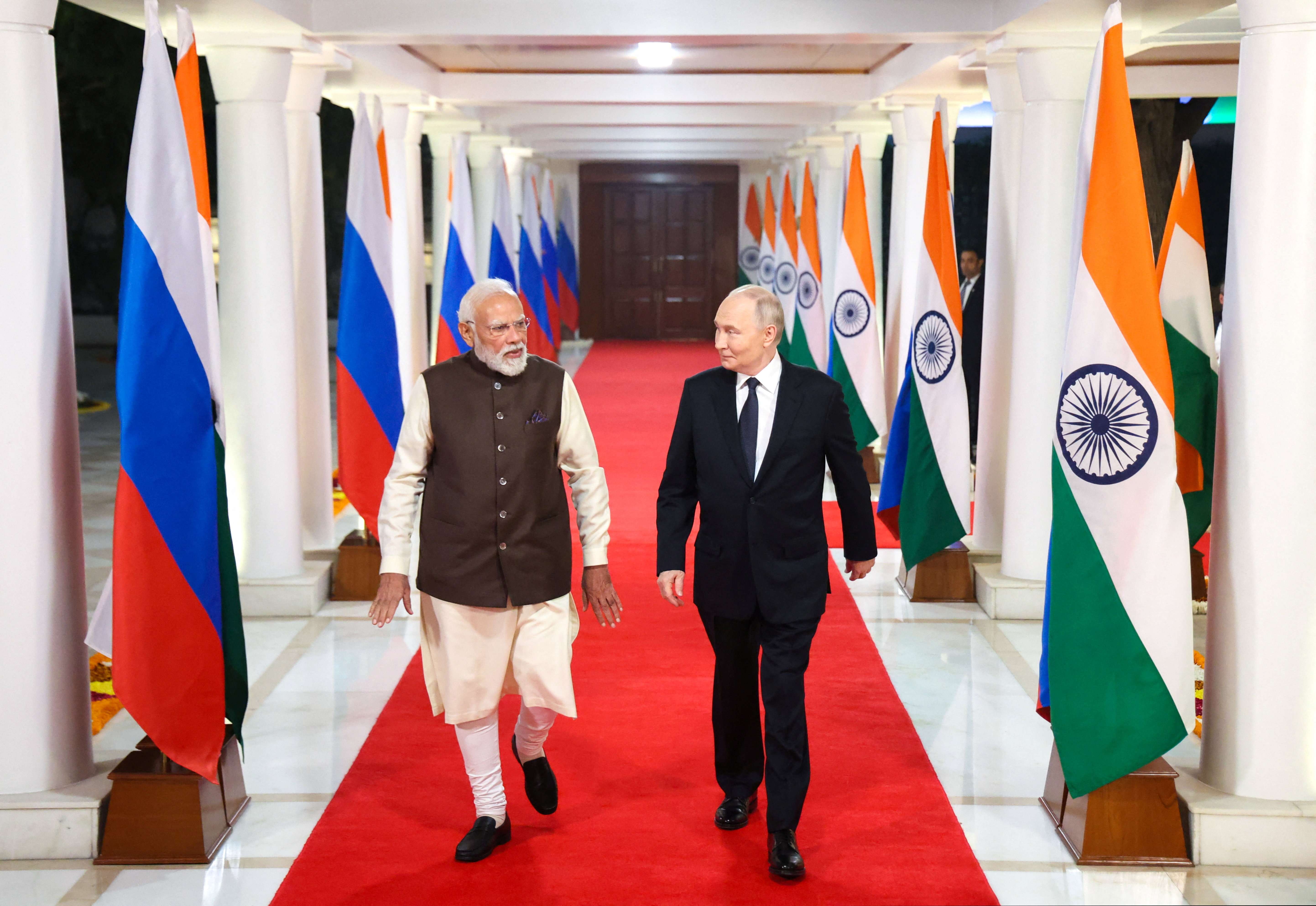 Russian President Vladimir Putin and Indian Prime Minister Narendra Modi arrive for an informal dinner at the Prime Minister's Residence in New Delhi, India December 4, 2025. Sputnik/Alexander Kazakov/Pool via REUTERS ATTENTION EDITORS - THIS IMAGE WAS PROVIDED BY A THIRD PARTY.