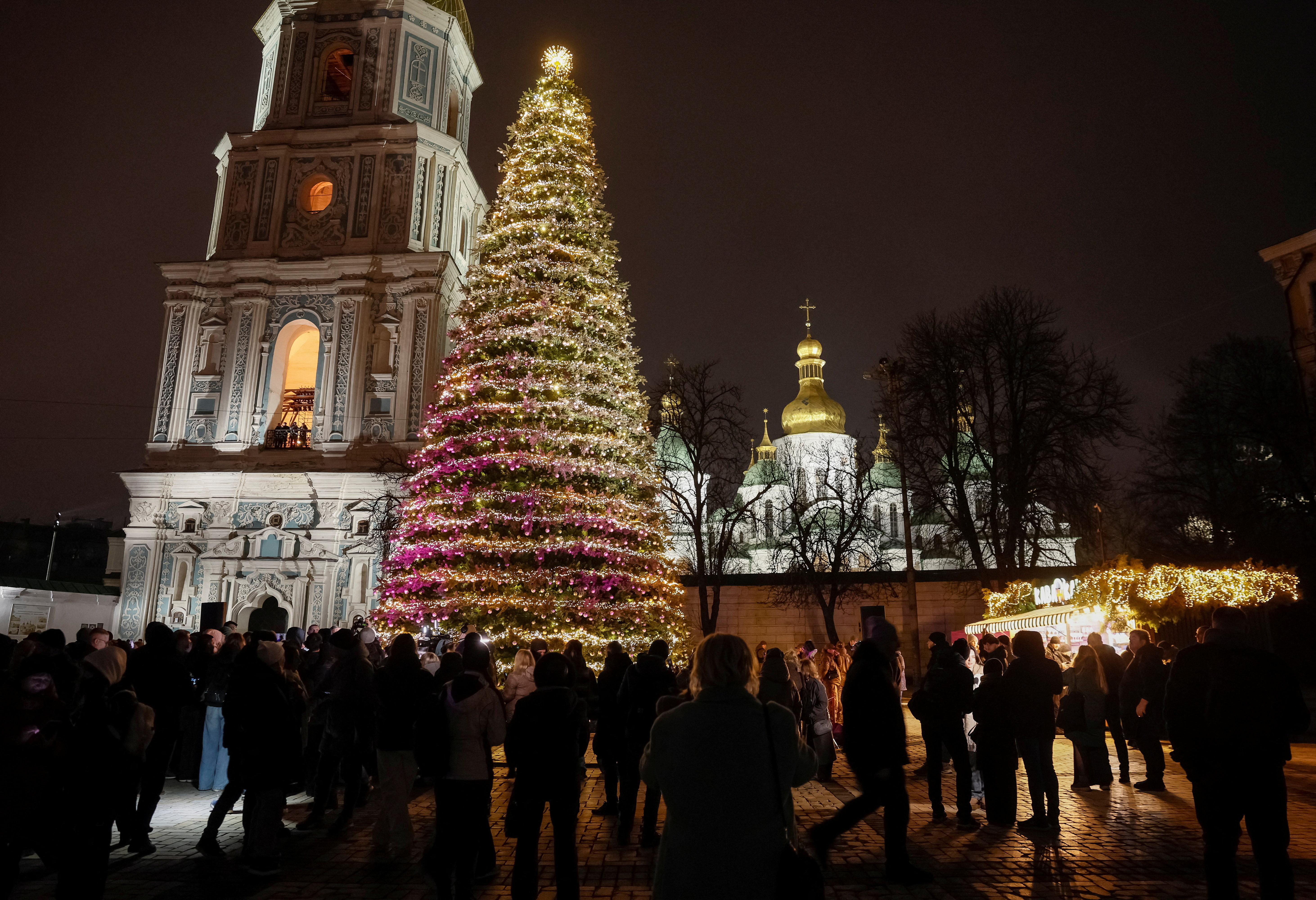 People gather around Ukraine's main Christmas tree after its lights were switched on, amid Russia's attack on Ukraine, in front of St. Sophia's Cathedral in Kyiv, Ukraine December 5, 2025. REUTERS/Gleb Garanich