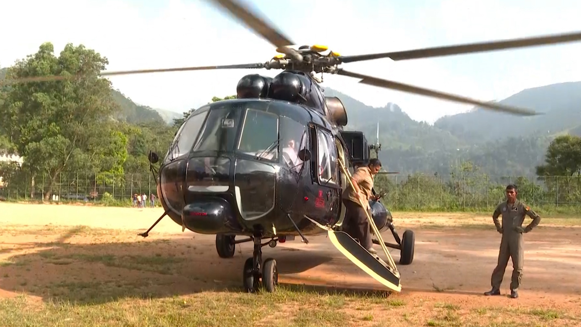 Al Jazeera&#039;s Minelle Fernandez climbs out of a Sri Lanka air force helicopter delivering aid to flood- and mudslide-devastated communities. [Al Jazeera]