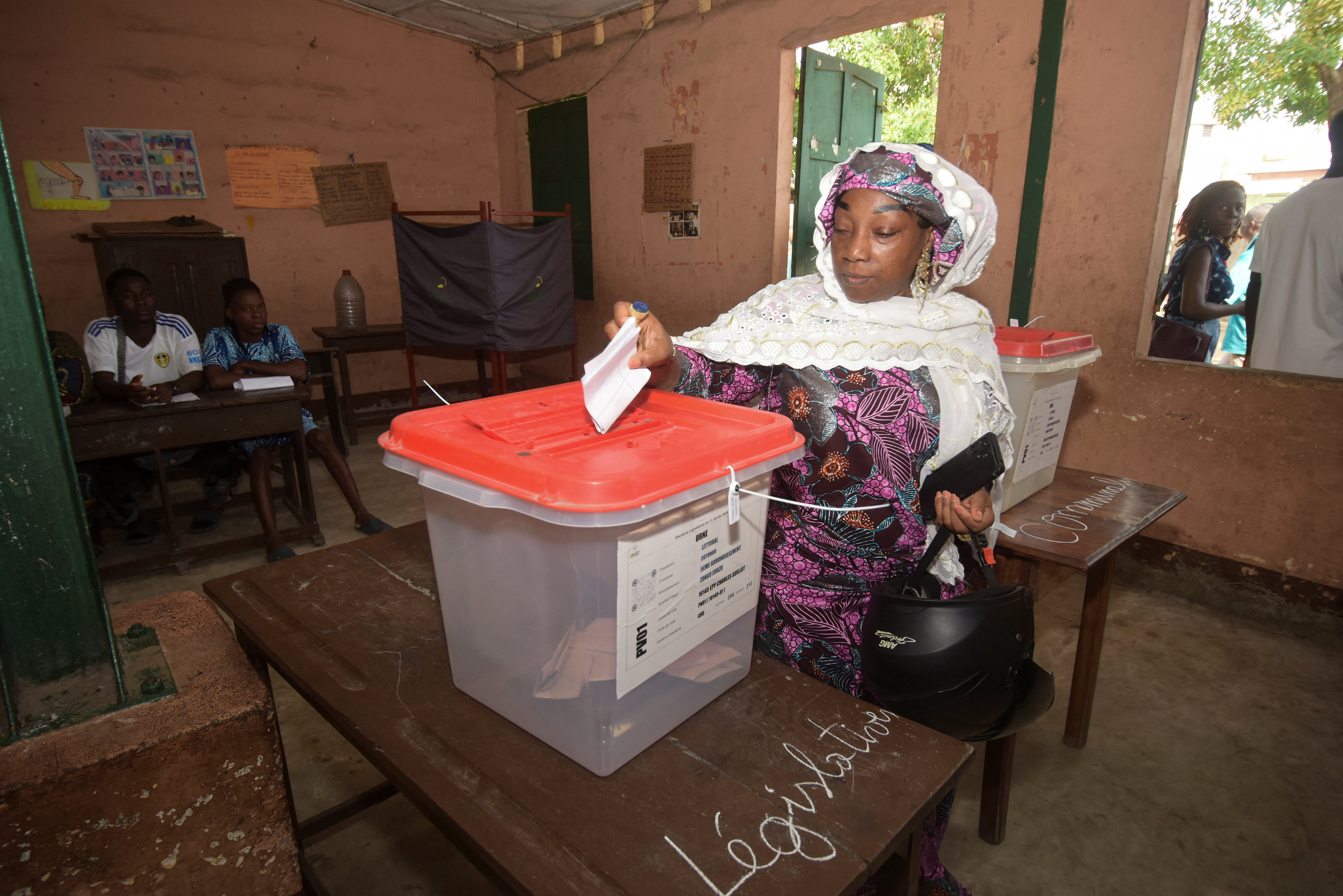 A woman casts her vote at a polling station during the parliamentary election, in Cotonou, Benin, in Janui. [Charles Placide Tossou/ Reuters]
