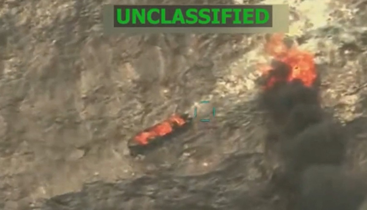 Screen grab from a video shows boats on fire in the sea.