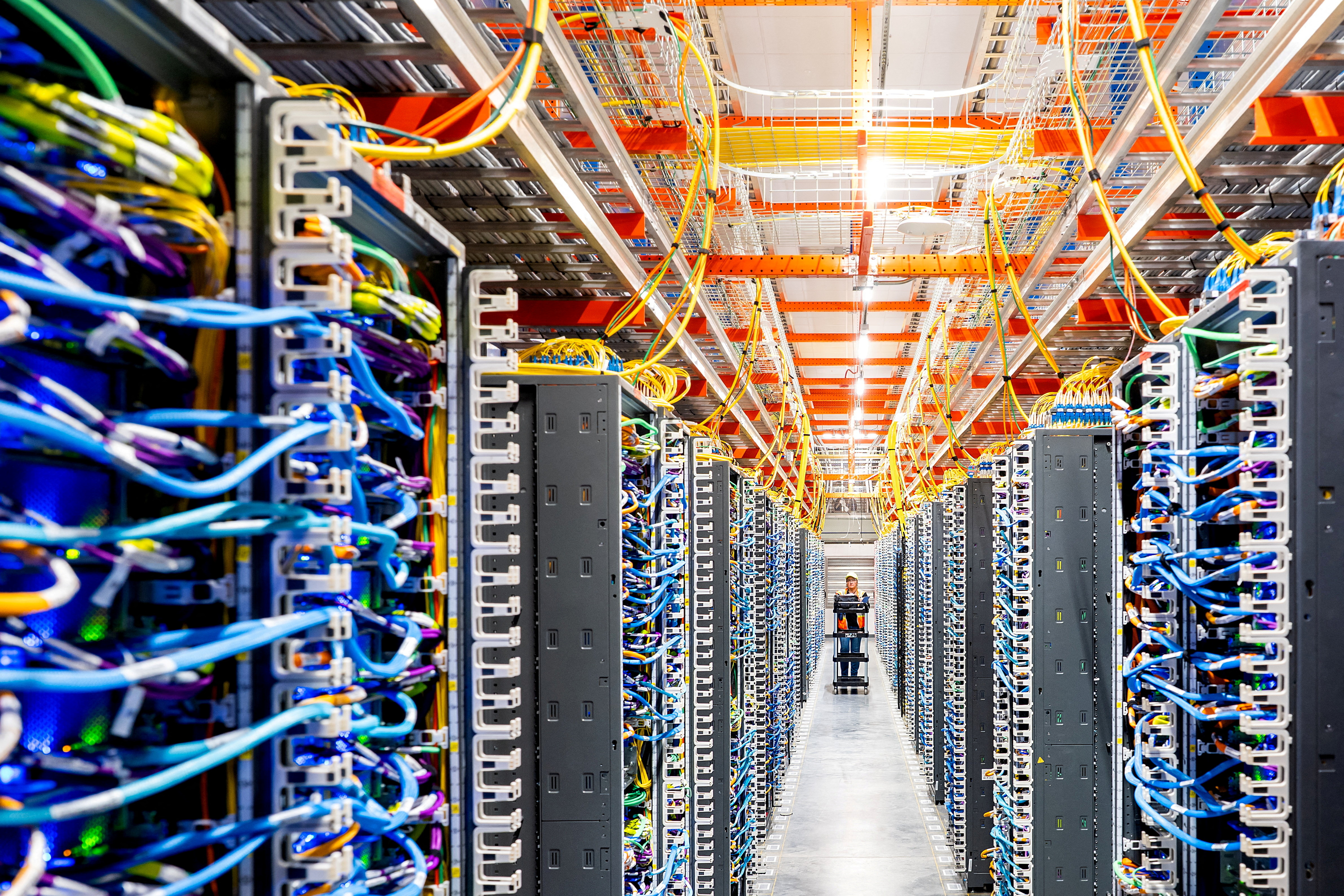 FILE PHOTO: A technician works at an Amazon Web Services AI data center in New Carlisle, Indiana, U.S., October 2, 2025. REUTERS/Noah Berger for AWS/File Photo
