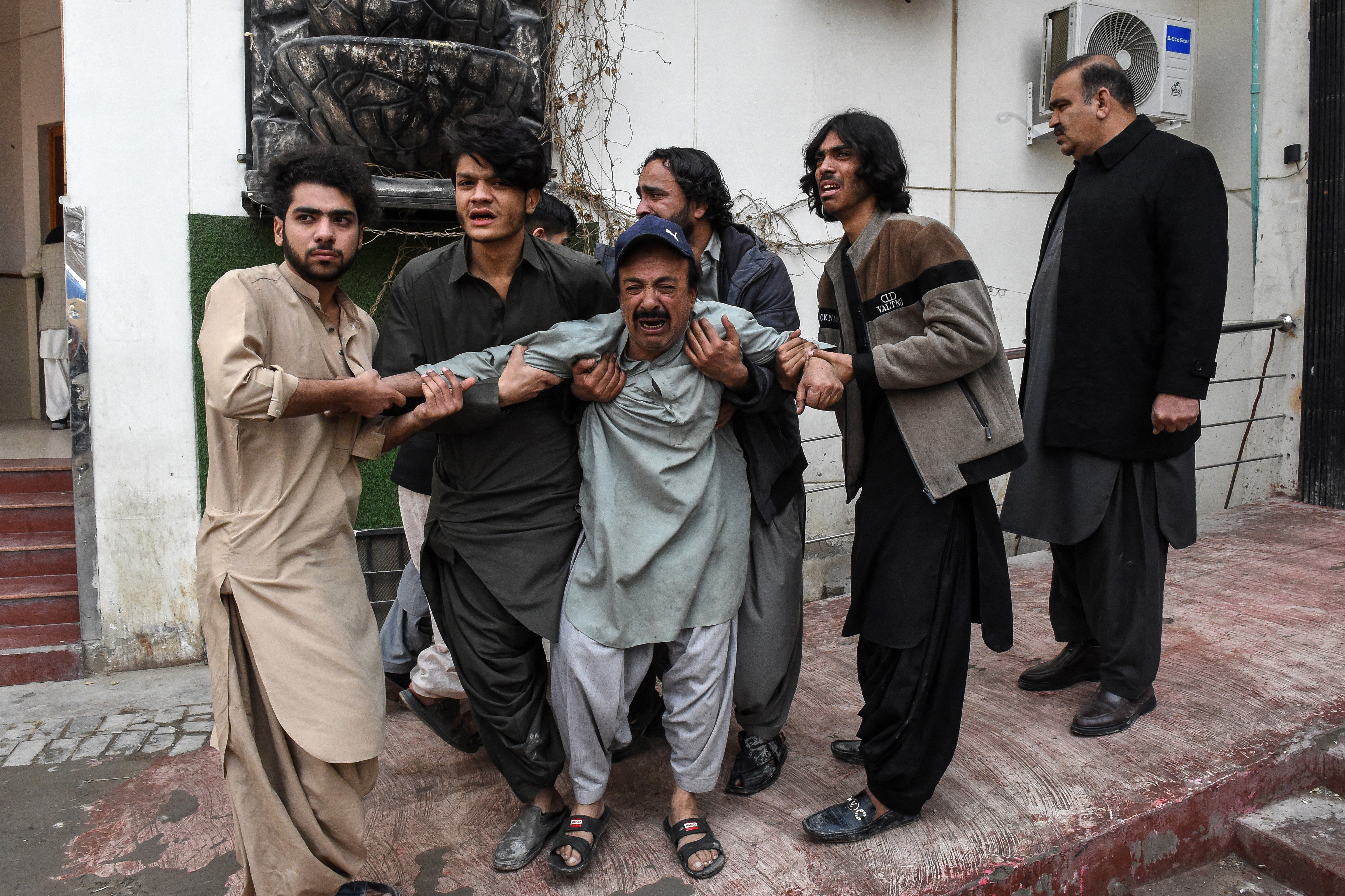 Family members mourn the death of a relative killed in an attack by Baloch separatists