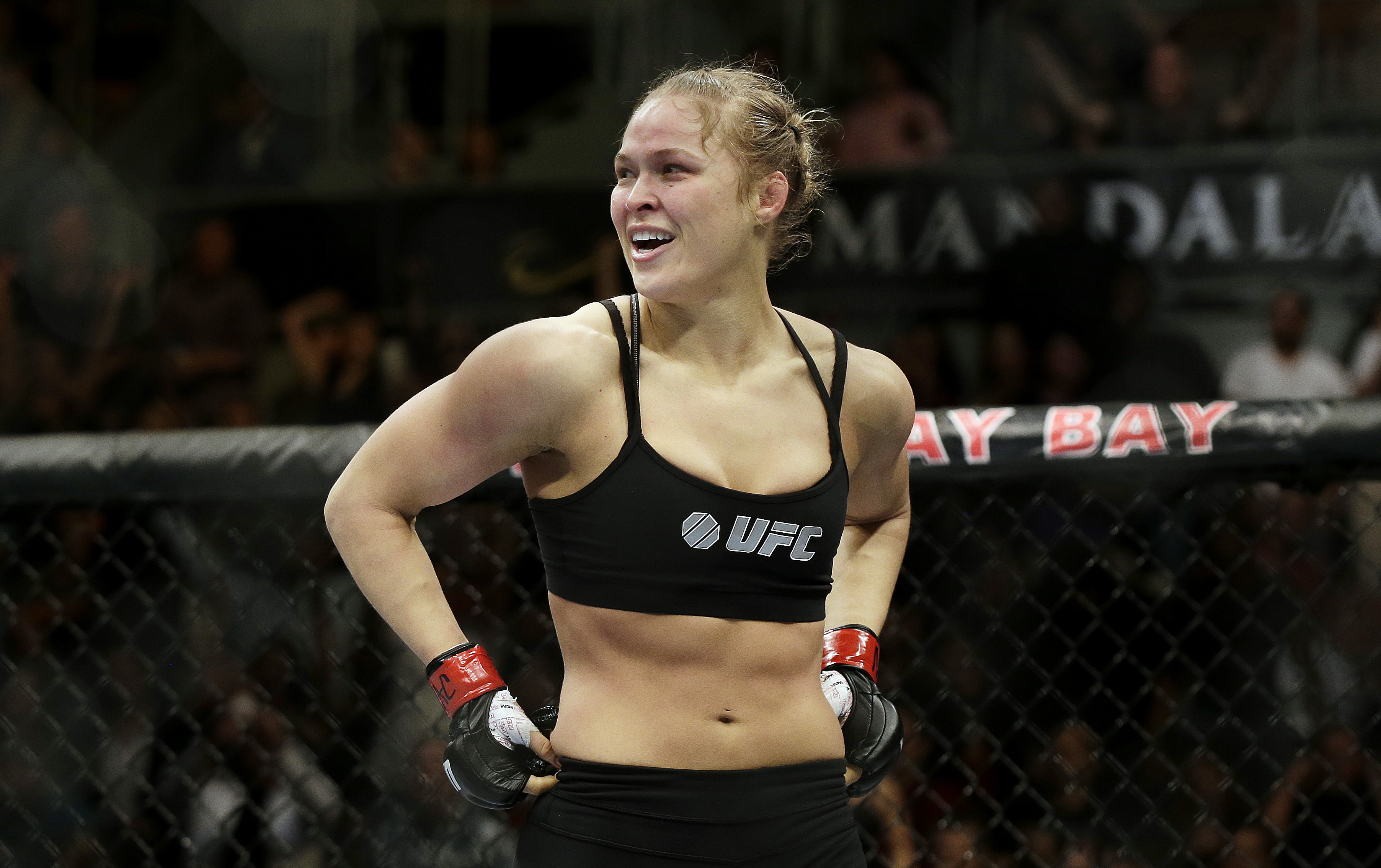 Ronda Rousey looks around in the ring.
