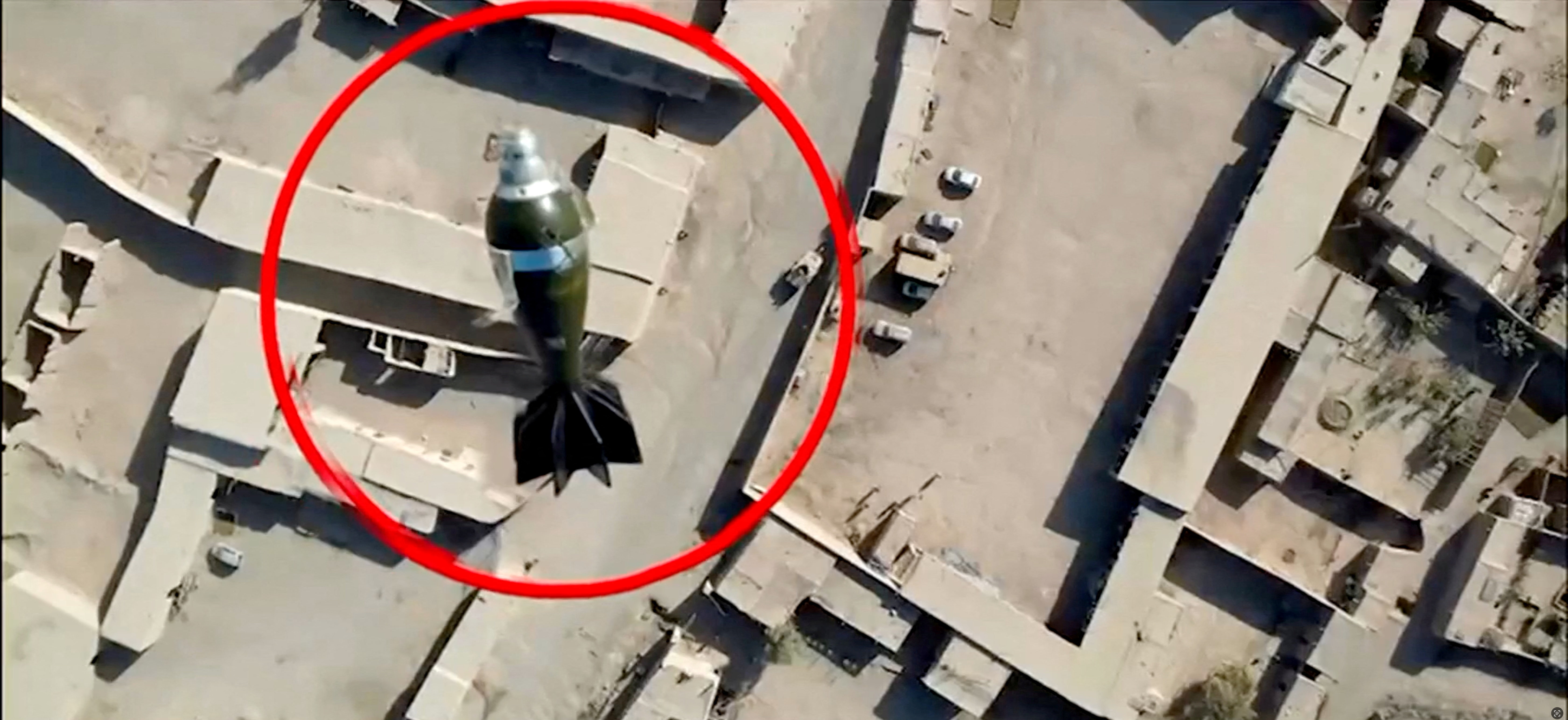 A mortar round falls towards a target from a drone, in this still image from handout video, said to show Pakistani forces conducting a strike on an Afghan Taliban border post, in Spin Boldak, Afghanistan, October 15, 2025. ISPR/Handout via REUTERS THIS IMAGE HAS BEEN SUPPLIED BY A THIRD PARTY. MANDATORY CREDIT. OVERLAYED CIRCLE GRAPHIC PROVIDED AT SOURCE. VERIFIED BY ROAD LAYOUT AND BUILDINGS WHICH MATCHED SATELLITE IMAGERY
