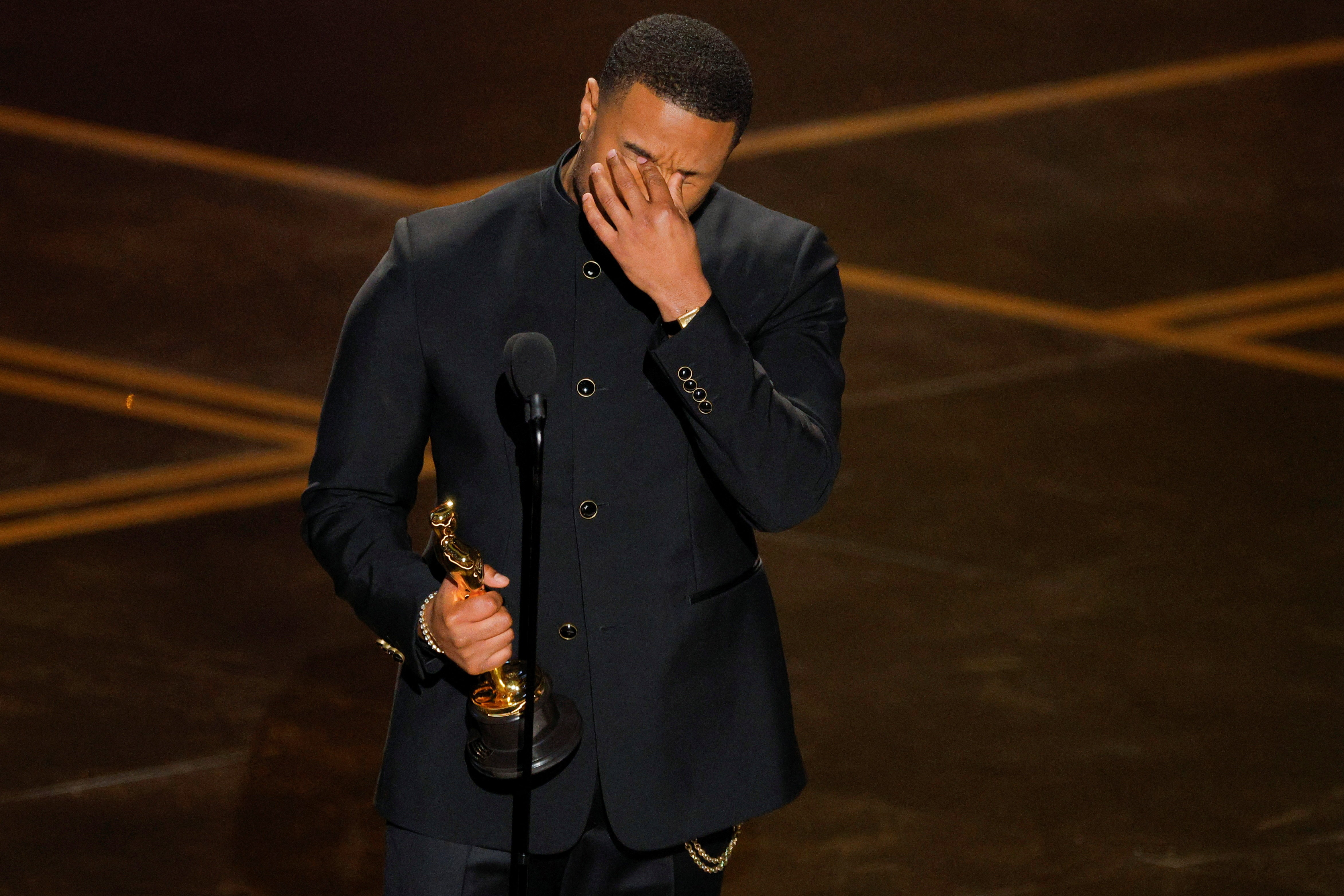 Michael B Jordan accepts an award at the Oscars