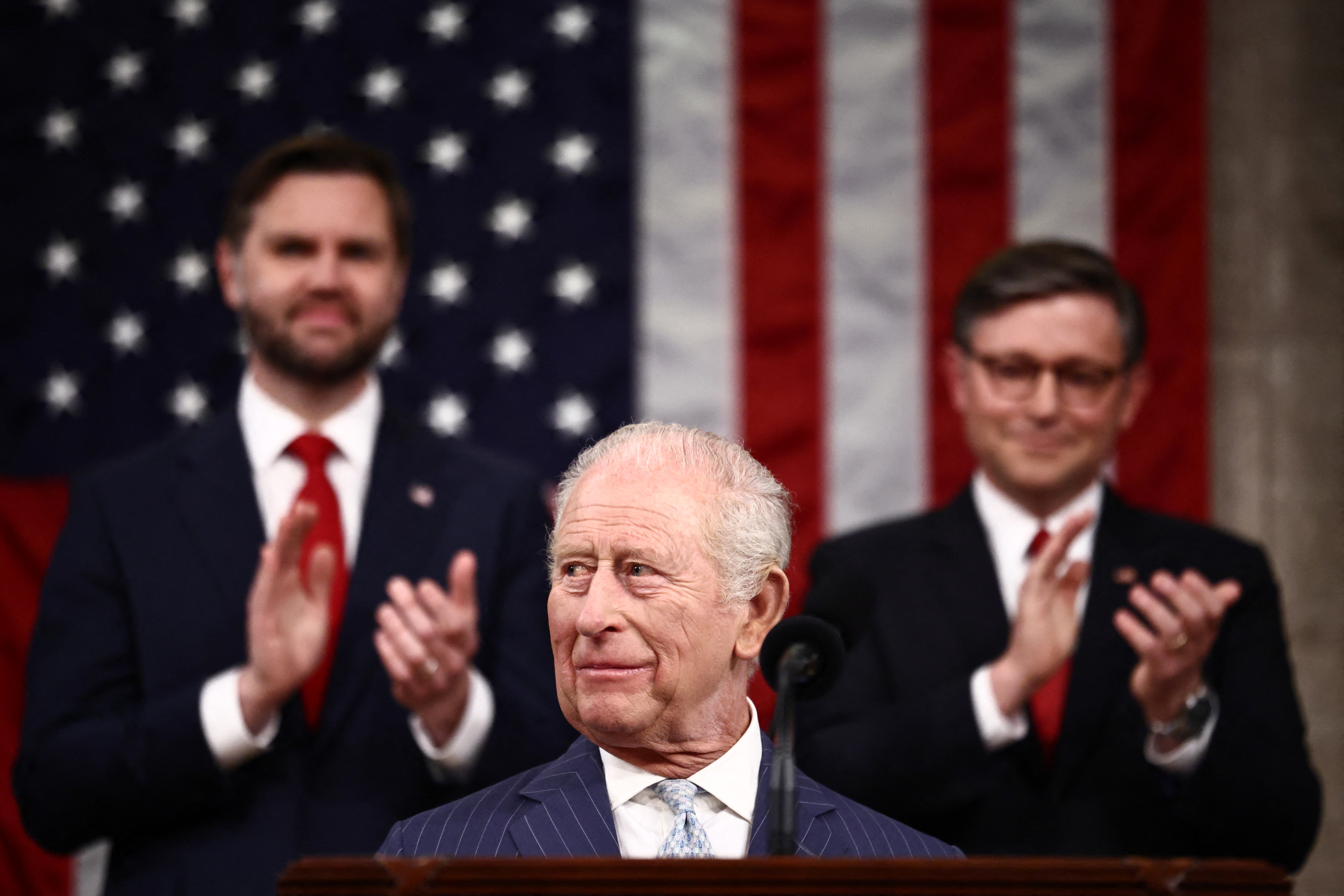 US Vice President JD Vance and House Speaker Mike Johnson applaud as Britain's King Charles III arrives to address a Joint Meeting of Congress in the House Chamber at the US Capitol in Washington, DC, on April 28, 2026. (Photo by Henry NICHOLLS / POOL / AFP)