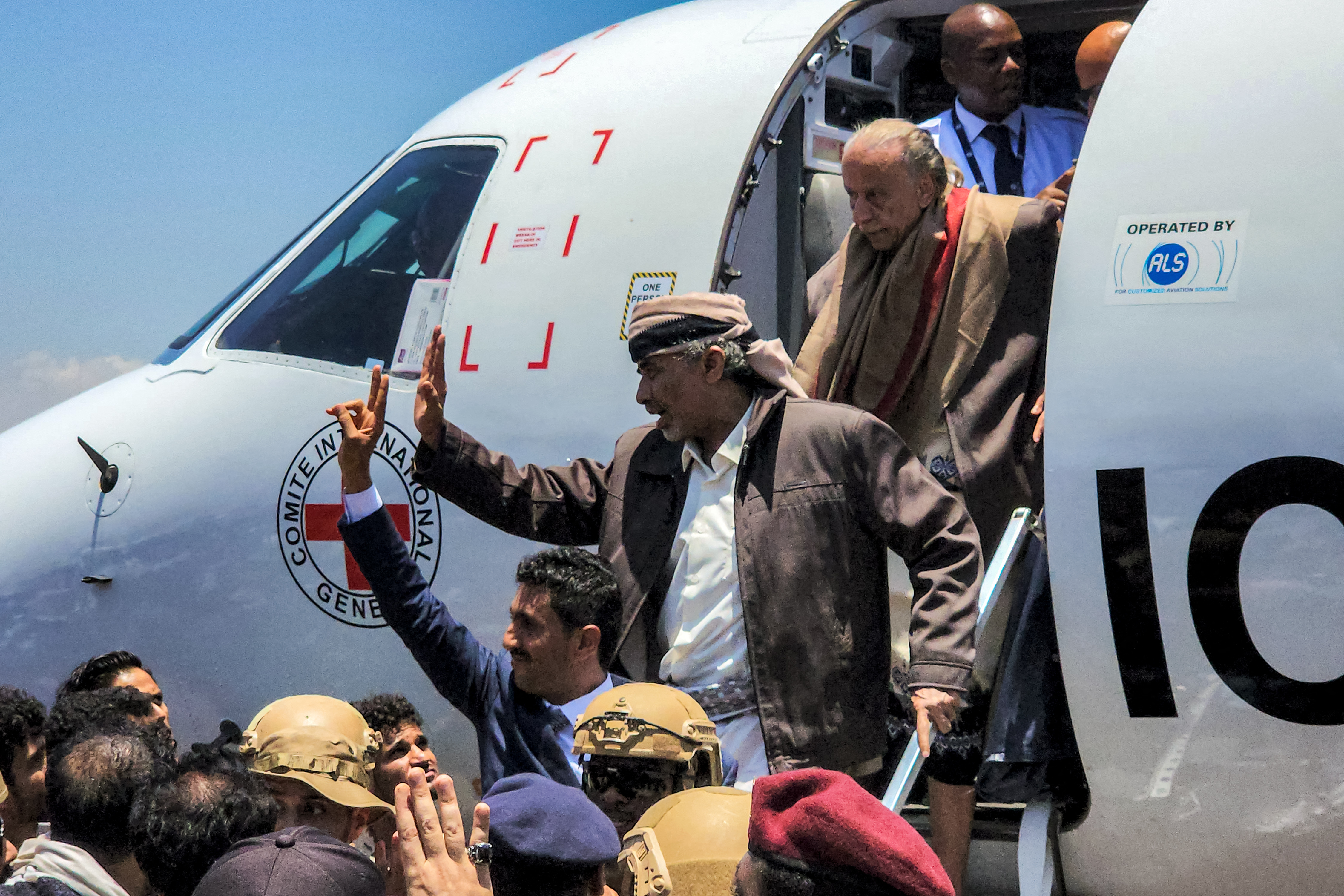 Yemeni negotiators and other officials disembark from a plane flying under the banner of the International Committee of the Red Cross (ICRC) upon arrival at Yemen's Aden International Airport on April 14, 2023 during a previous prisoner exchange with the Houthi group [File: Saleh Al-Obeidi/AFPB]