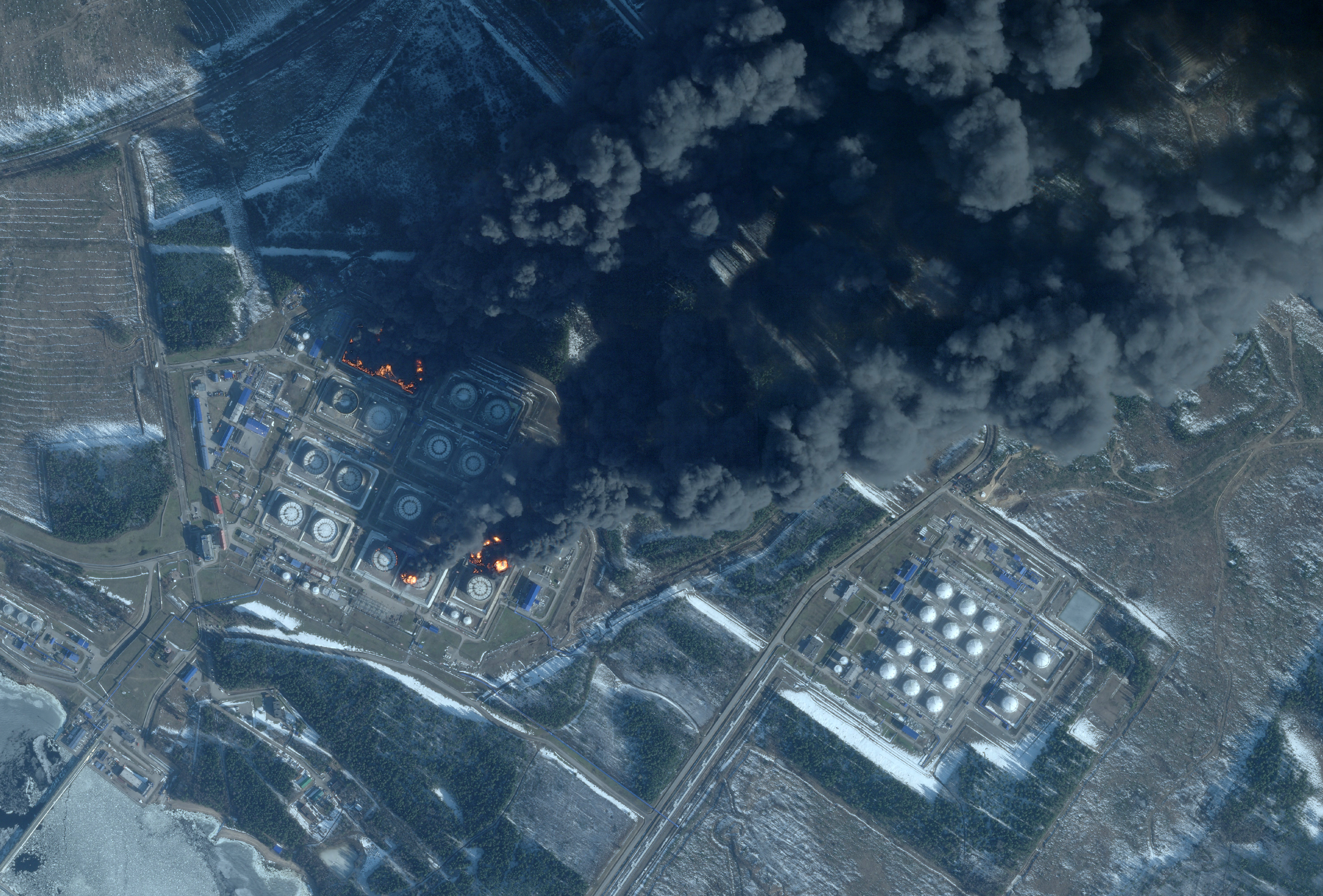 This handout satellite image taken on March 23, 2026 by Planet Labs PBC shows smoke rising from the Russian oil terminal at Primorsk, the most important Russian loading port in the Baltic Sea, following a drone attack claimed by Ukraine. The Russian port of Primorsk, near the Finnish border, suffered damage in the latest round of drone attacks, the region's governor announced on March 23, 2026, with Ukraine claiming responsibility.