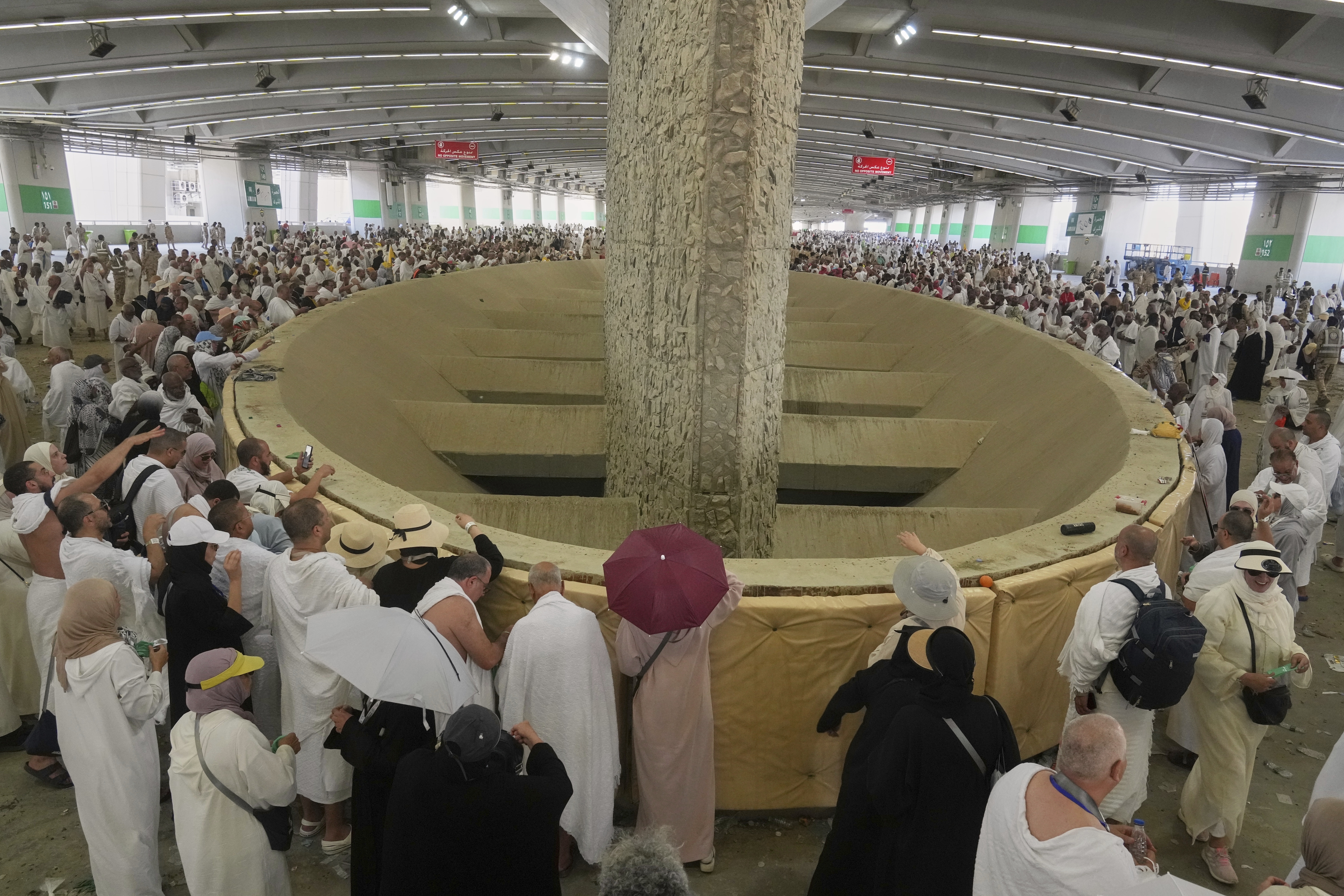 Muslim pilgrims cast stones at pillars in the symbolic stoning of the devil, the last rite of the annual Hajj, in Mina near the holy city of Mecca, Saudi Arabia, Friday, June 6, 2025. (AP Photo/Amr Nabil)