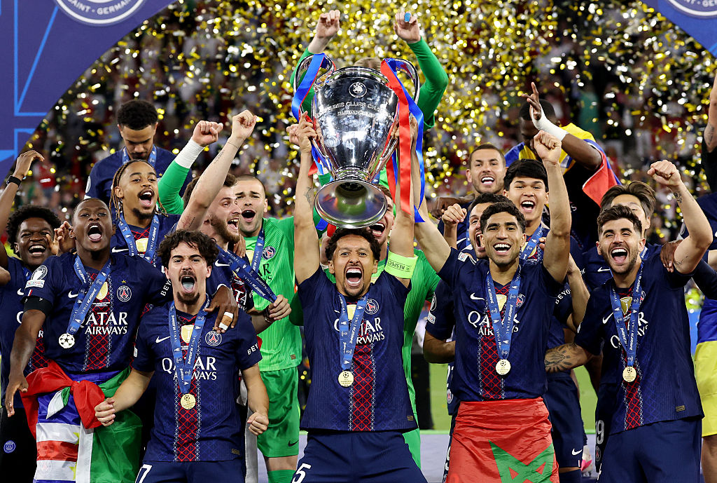 Marquinhos of Paris Saint-Germain lifts the UEFA Champions League trophy after his team's victory in the UEFA Champions League Final