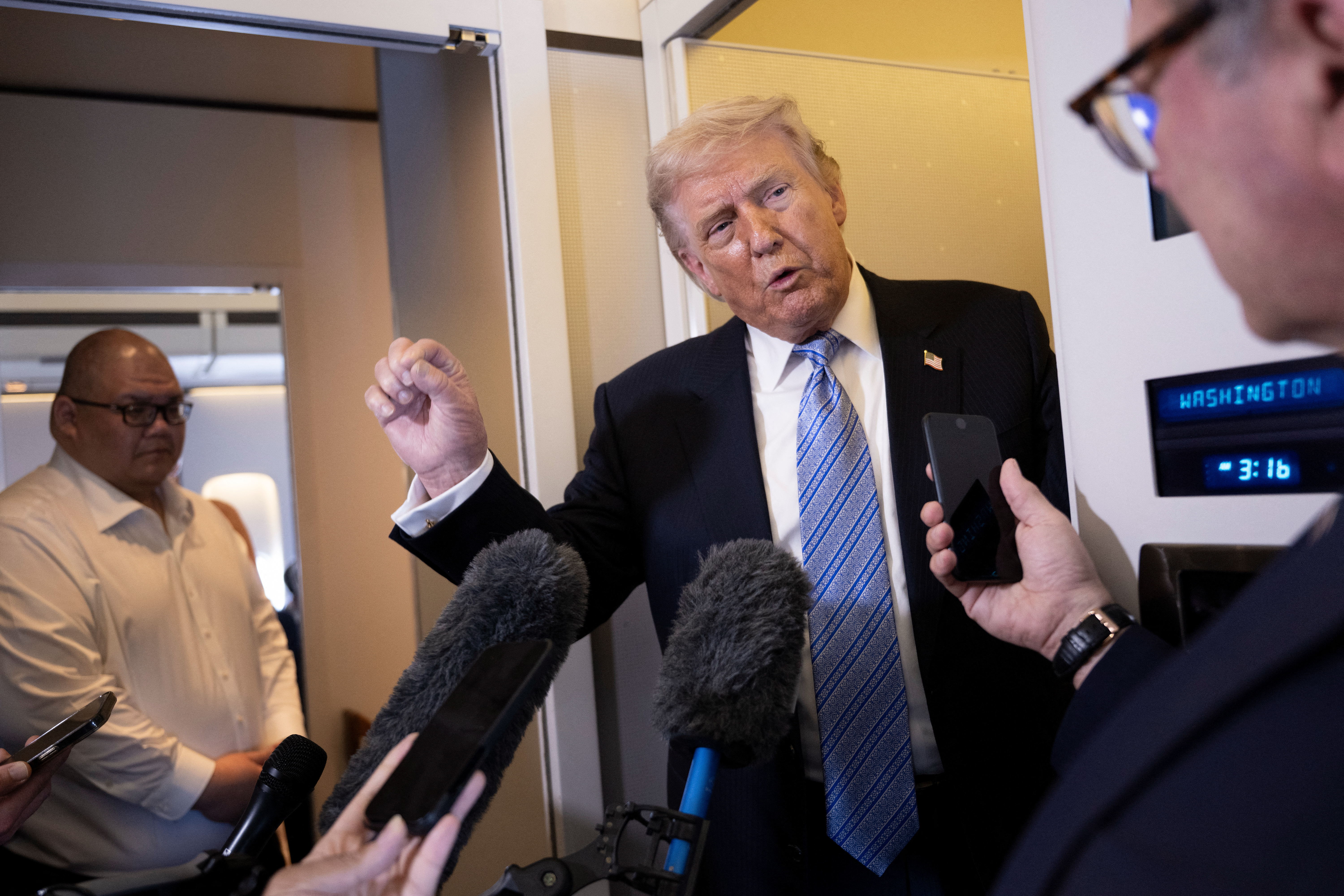 US President Donald Trump speaks to reporters aboard Air Force One after his departure from Beijing Capital Airport on May 15, 2026, on his way back to the United States.
