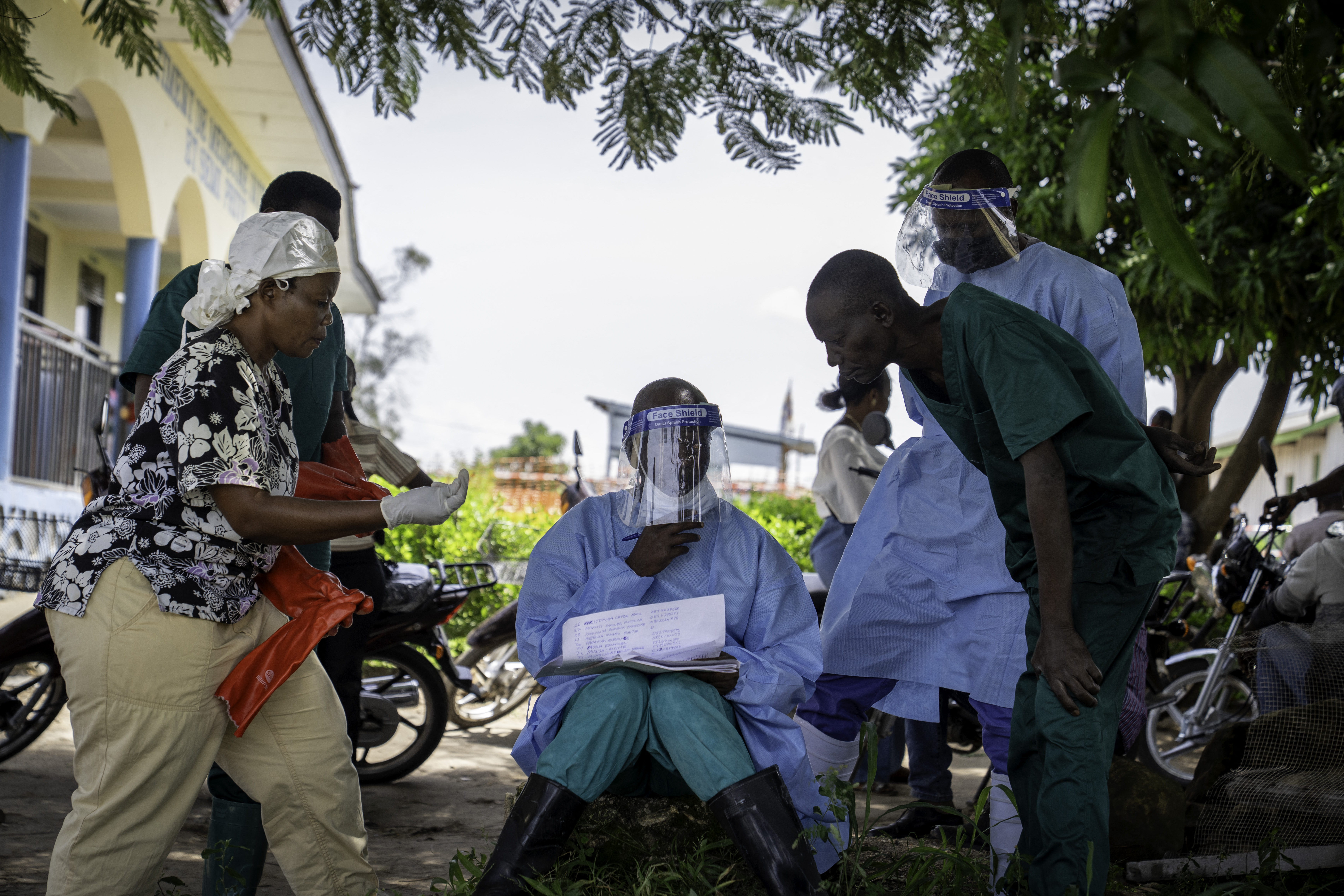 A health worker shows his colleagues the list of patients at Rwampara Hospital in Ituri, in the eastern Democratic Republic of the Congo