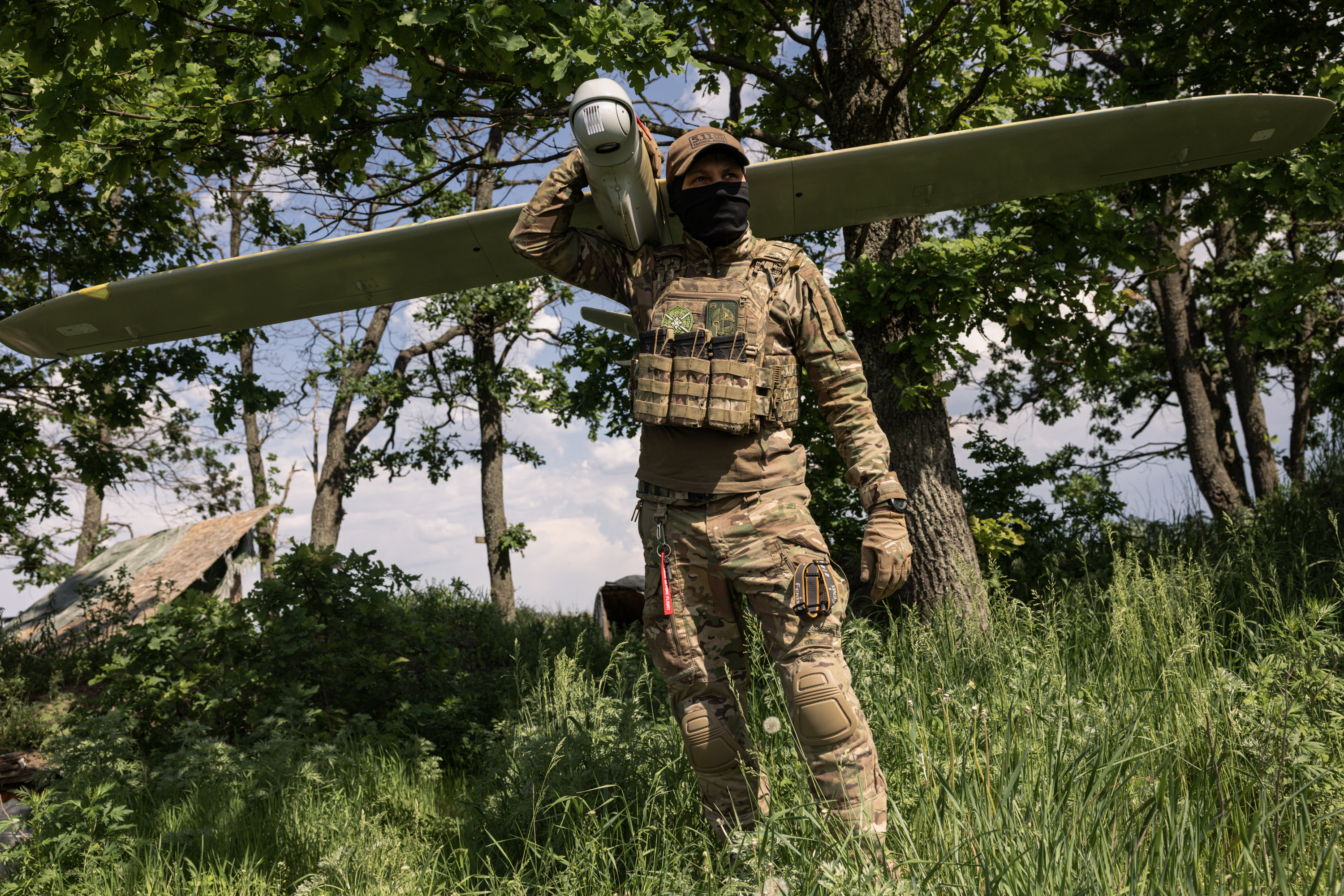 KHARKIV REGION, UKRAINE - MAY 22: (EDITOR'S NOTE: Image has been reviewed by Ukrainian military officials prior to transmission) Member of the Lava Unmanned Systems Regiment, Norman, poses for a photograph with a Leleka reconnaissance UAV, capable of flying up to 120 kilometres and returning to base, on May 22, 2026 in Kharkiv region, Ukraine. The Lava Unmanned Systems Regiment, part of the 2nd Khartiia Corps of the Ukrainian National Guard, is a specialized unit focused on combat operations using drones and robotic systems, including deep reconnaissance and precision strikes behind enemy lines. Originally formed as a battalion in 2025, the unit was expanded into a regiment in 2026 as Ukraine increasingly relies on unmanned technologies in warfare. (Photo by Diego Fedele/Getty Images)