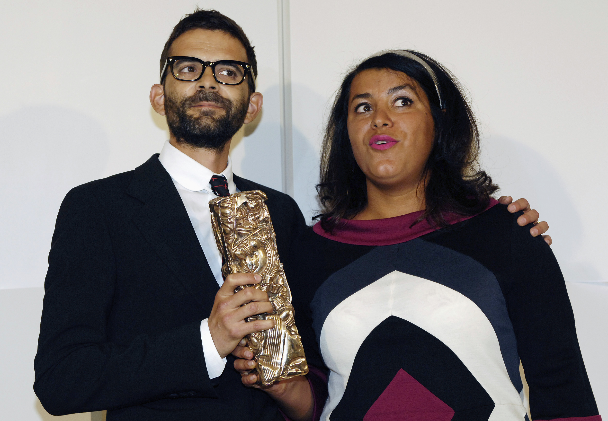 French directors Marjane Satrapi (R) and Vincent Paronnaud pose with their award for best debut film for
