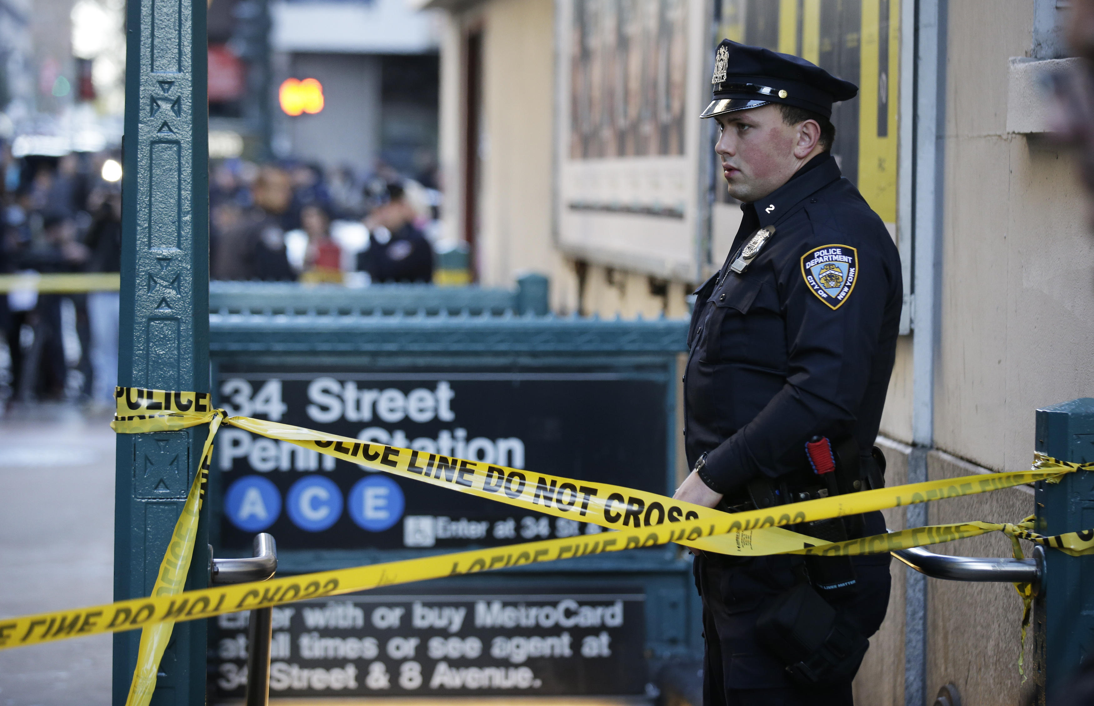 A NYPD officer stands guard near the Penn Station where streets have been closed following an early morning shooting in Manhattan New York, November 9, 2015. One person was killed and two others injured in a shooting near Penn Station, the key intercity railway hub in New York City, early on Monday, police said. REUTERS/Brendan McDermid