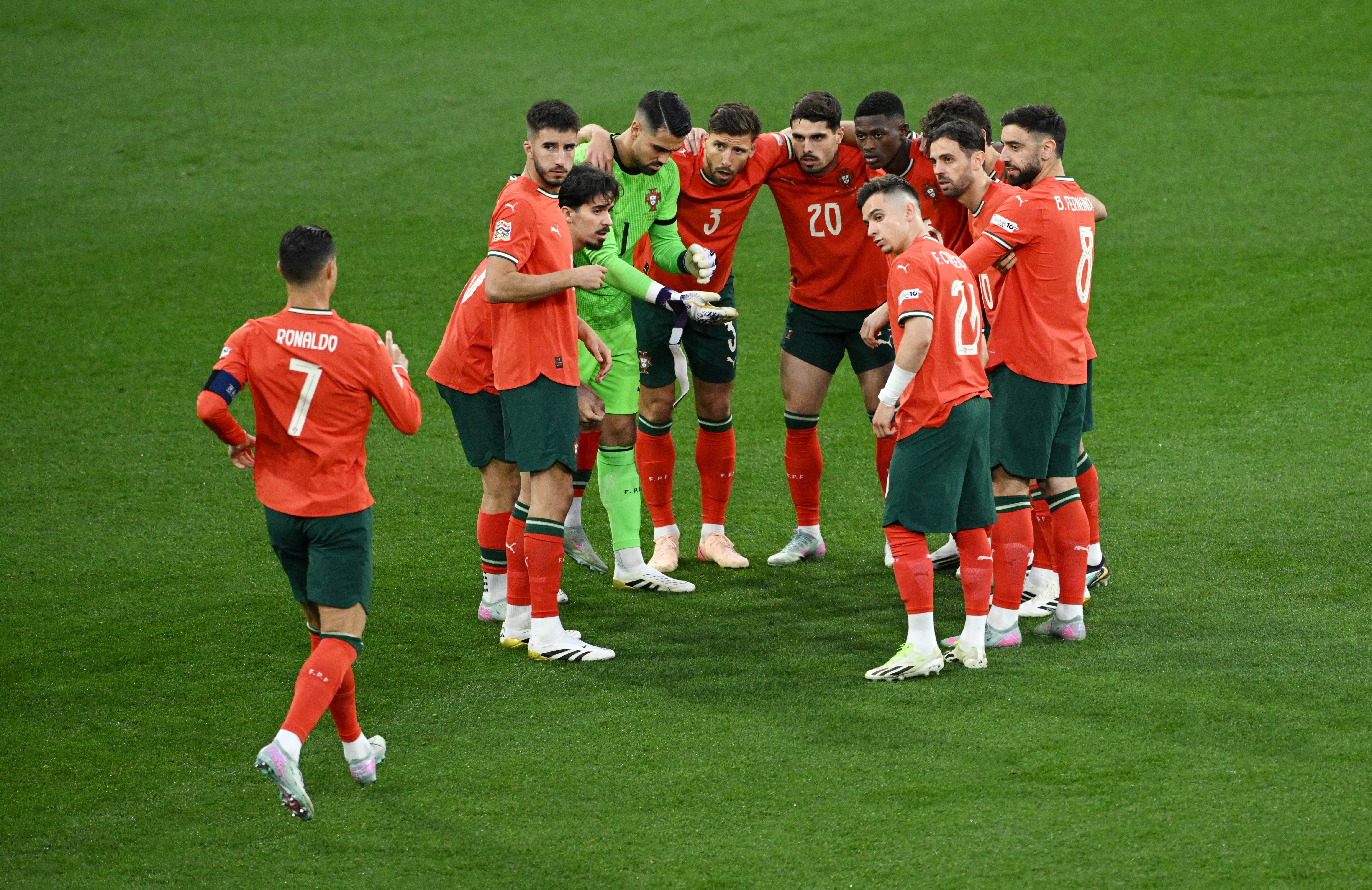 Portugal's Cristiano Ronaldo with teammates huddle before a match.