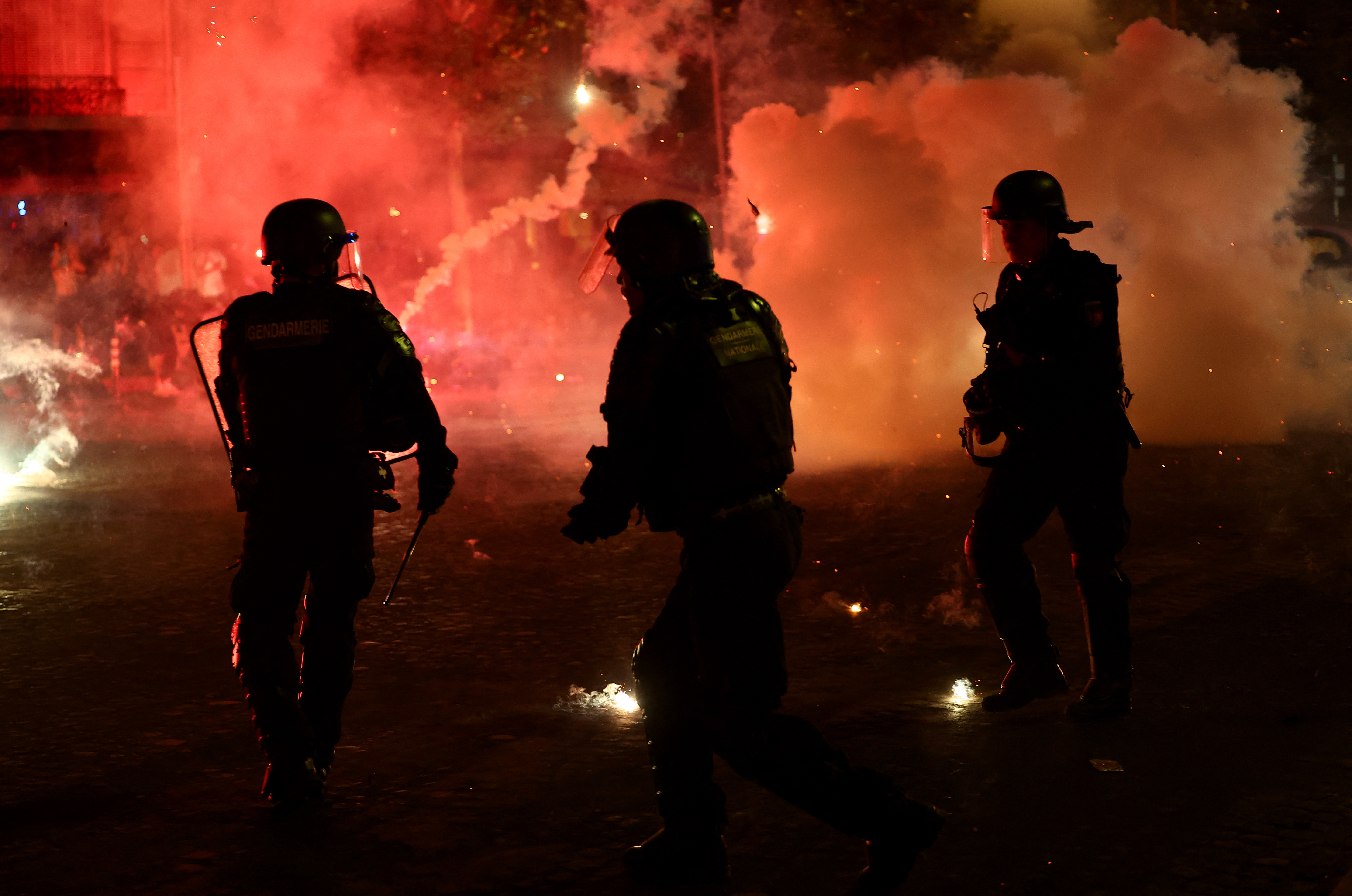 Police shield from flares thrown in Paris after PSG's Champions League win