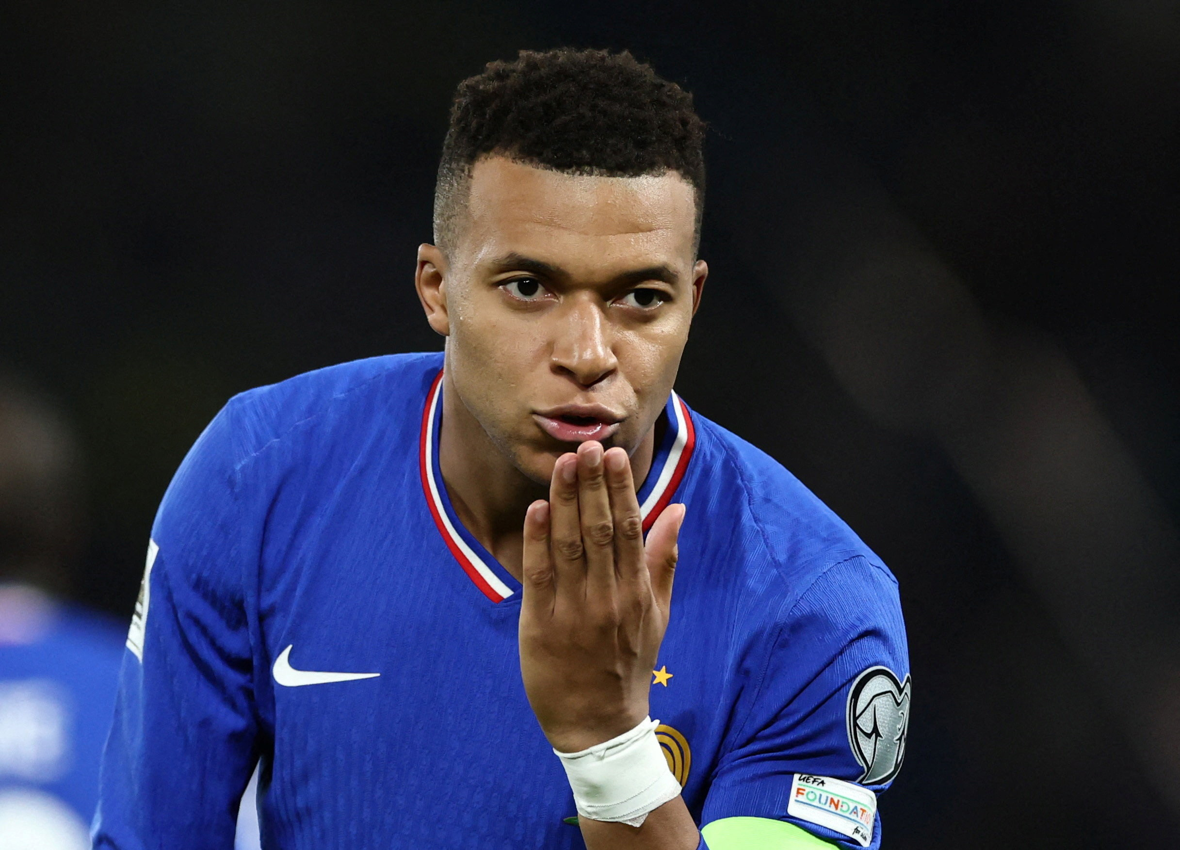 Mbappe kisses his hand in celebration