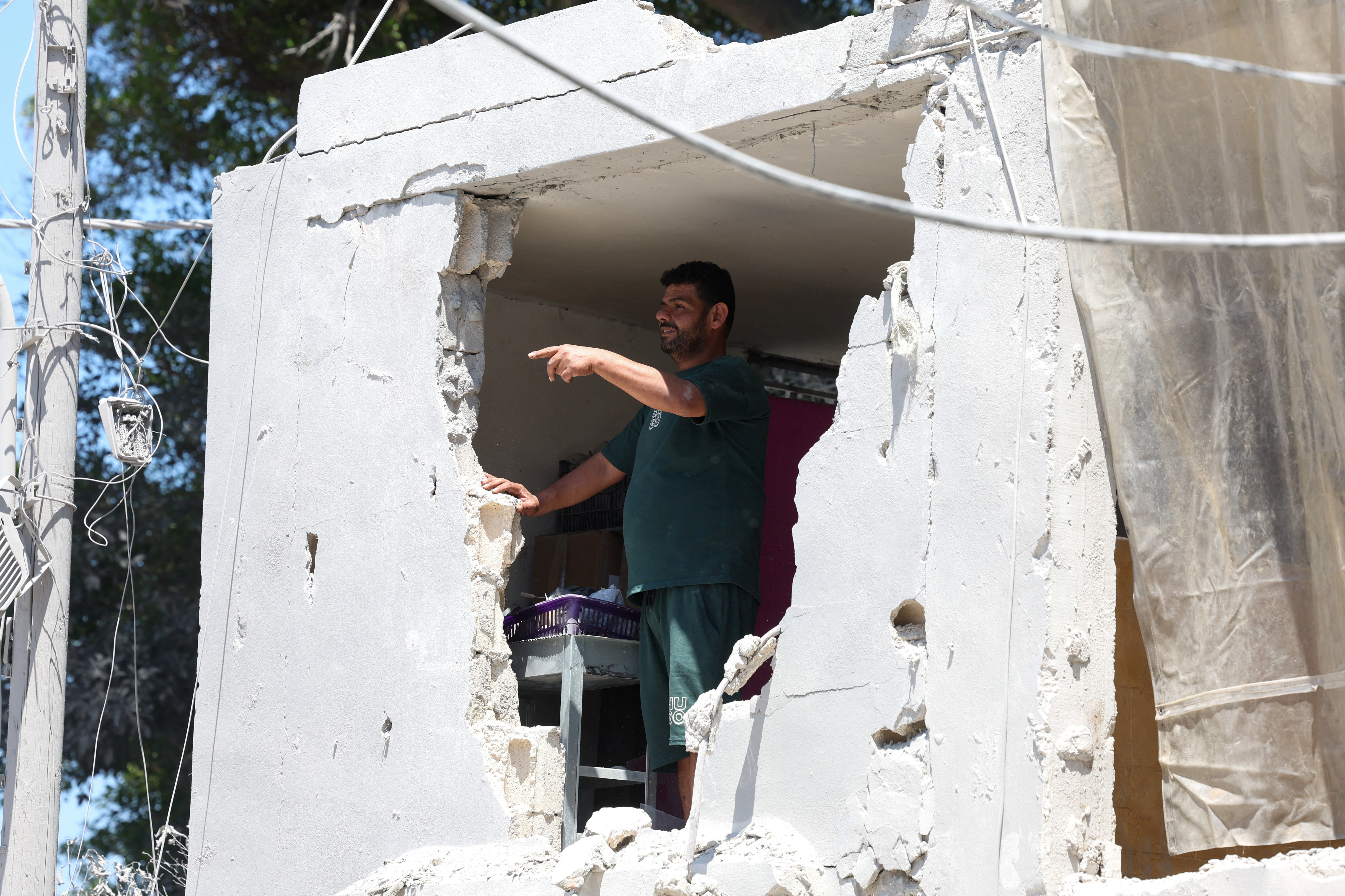 A man inspects damage at the site an Israeli strike in Tyre, Lebanon, June 12, 2026. REUTERS/Aziz Taher