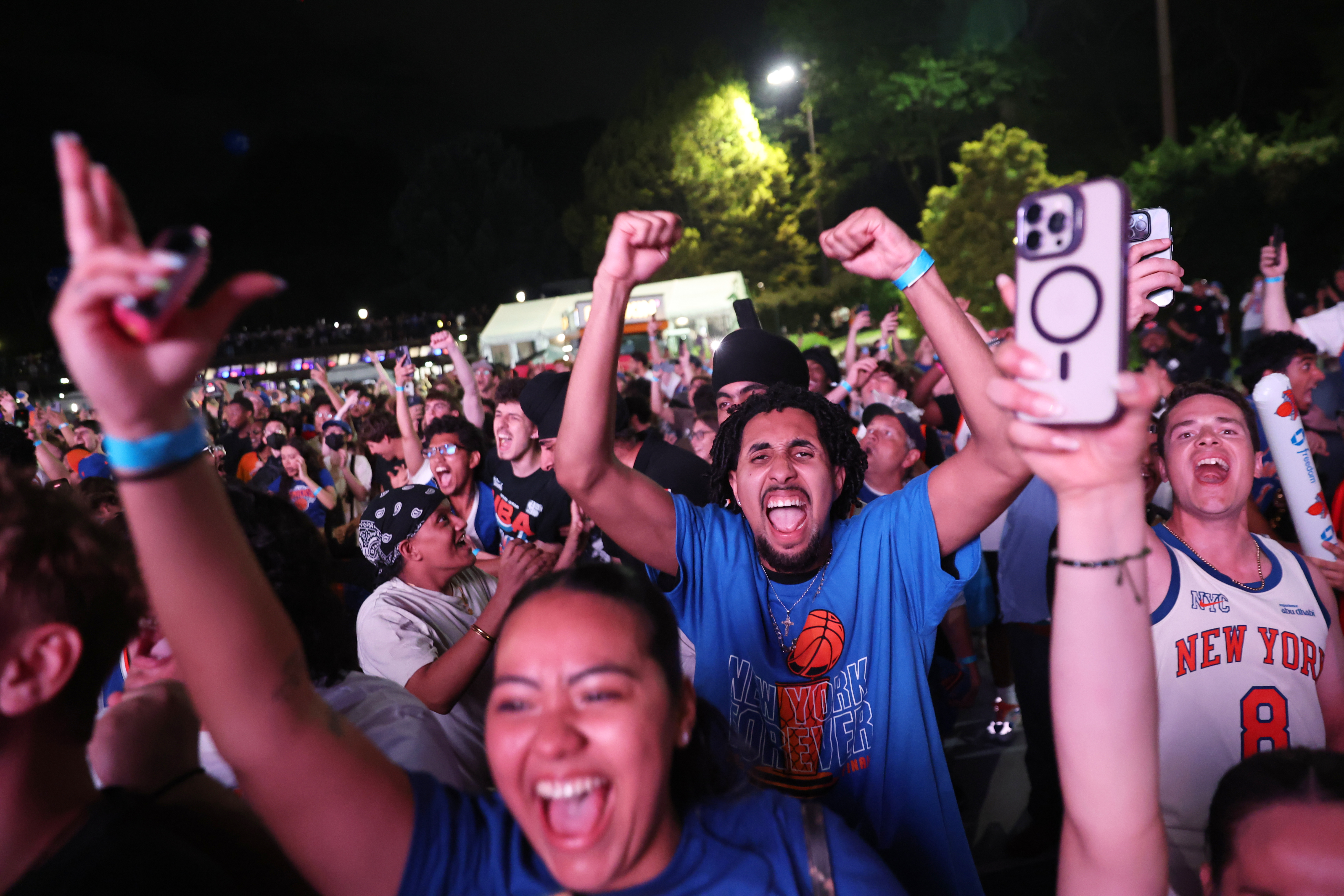 New York Knicks fans celebrate during a watch party inside Central Park during Game 4 of the NBA Finals basketball series between the Knicks and the San Antonio Spurs, Wednesday, June 10, 2026, in New York. (AP Photo/Heather Khalifa)
