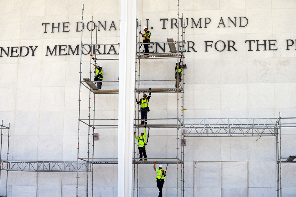 a worker removes Trump's name from the facade of the kennedy center