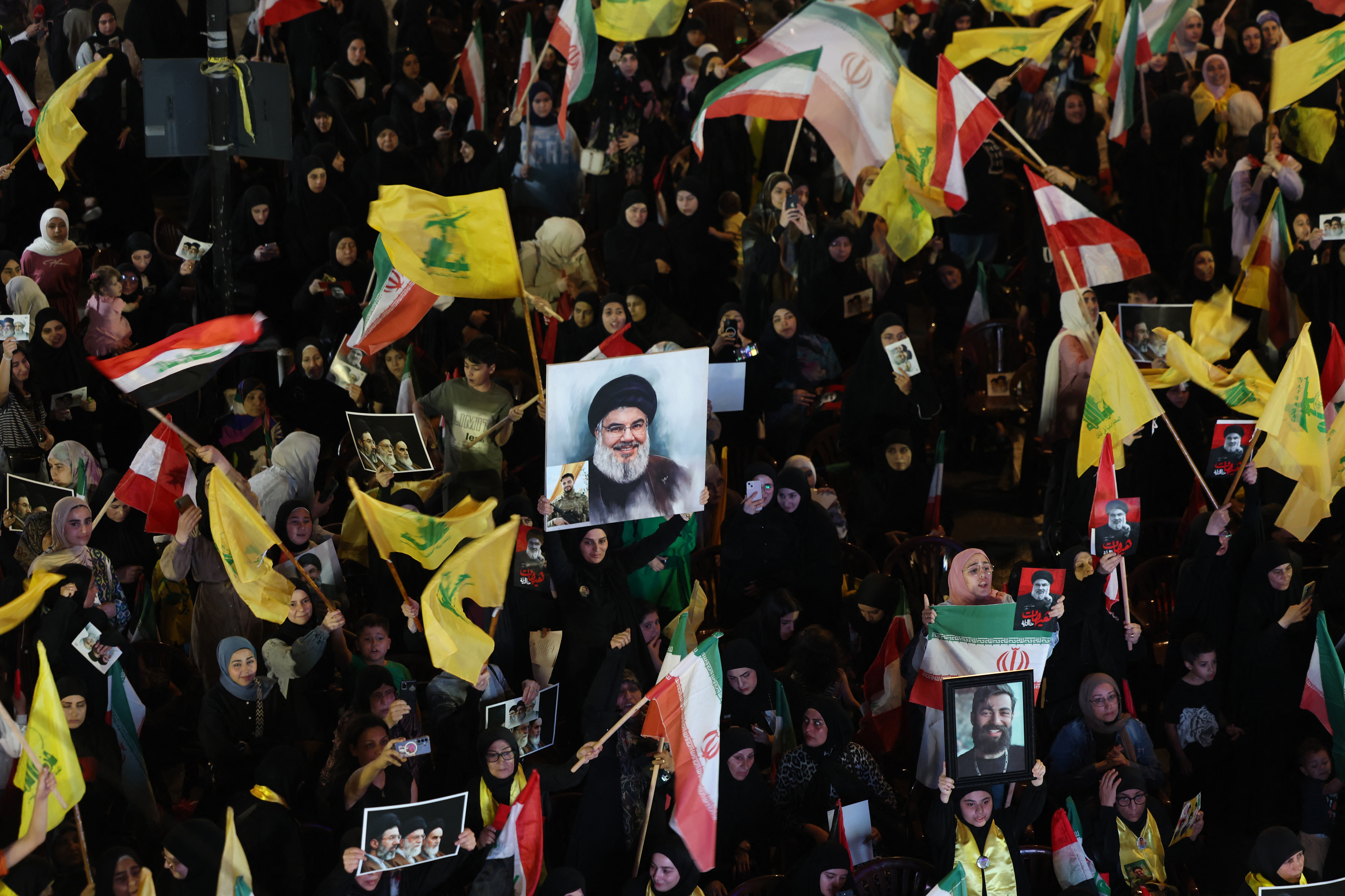 Supporters of Iran-backed armed group Hezbollah, wave flags and hold a portrait of slain leader Hassan Nasrallah during an anti-US and anti-Israel protest organised by the International Popular Committees to Resist Aggression in Beirut’s southern suburbs on June 10, 2026.