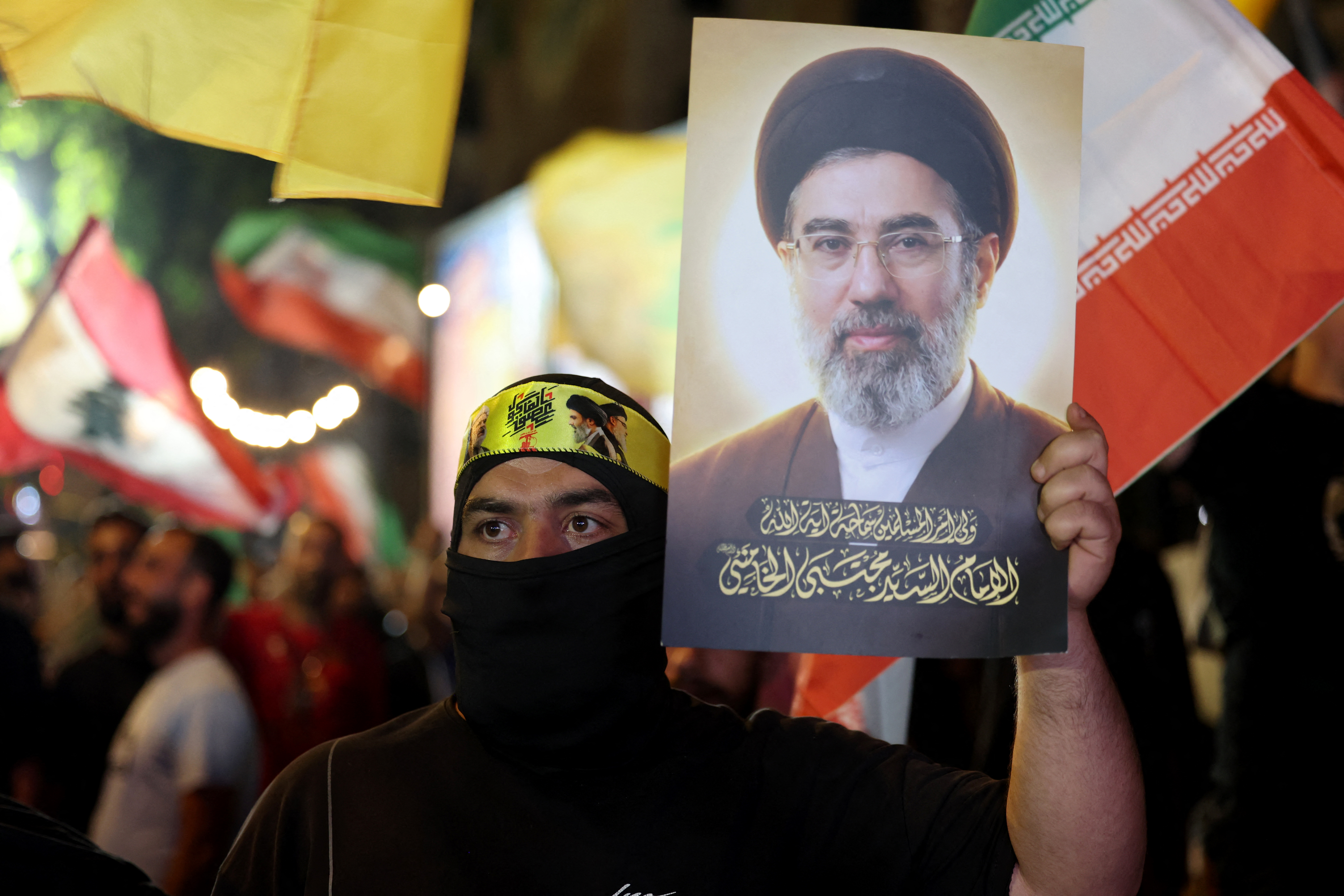A supporter of Iran-backed armed group Hezbollah, holds a portrait of Iran's supreme leader Mojtaba Khamenei during an anti-US and anti-Israel protest organised by the International Popular Committees to Resist Aggression in Beirut’s southern suburbs on June 10, 2026.