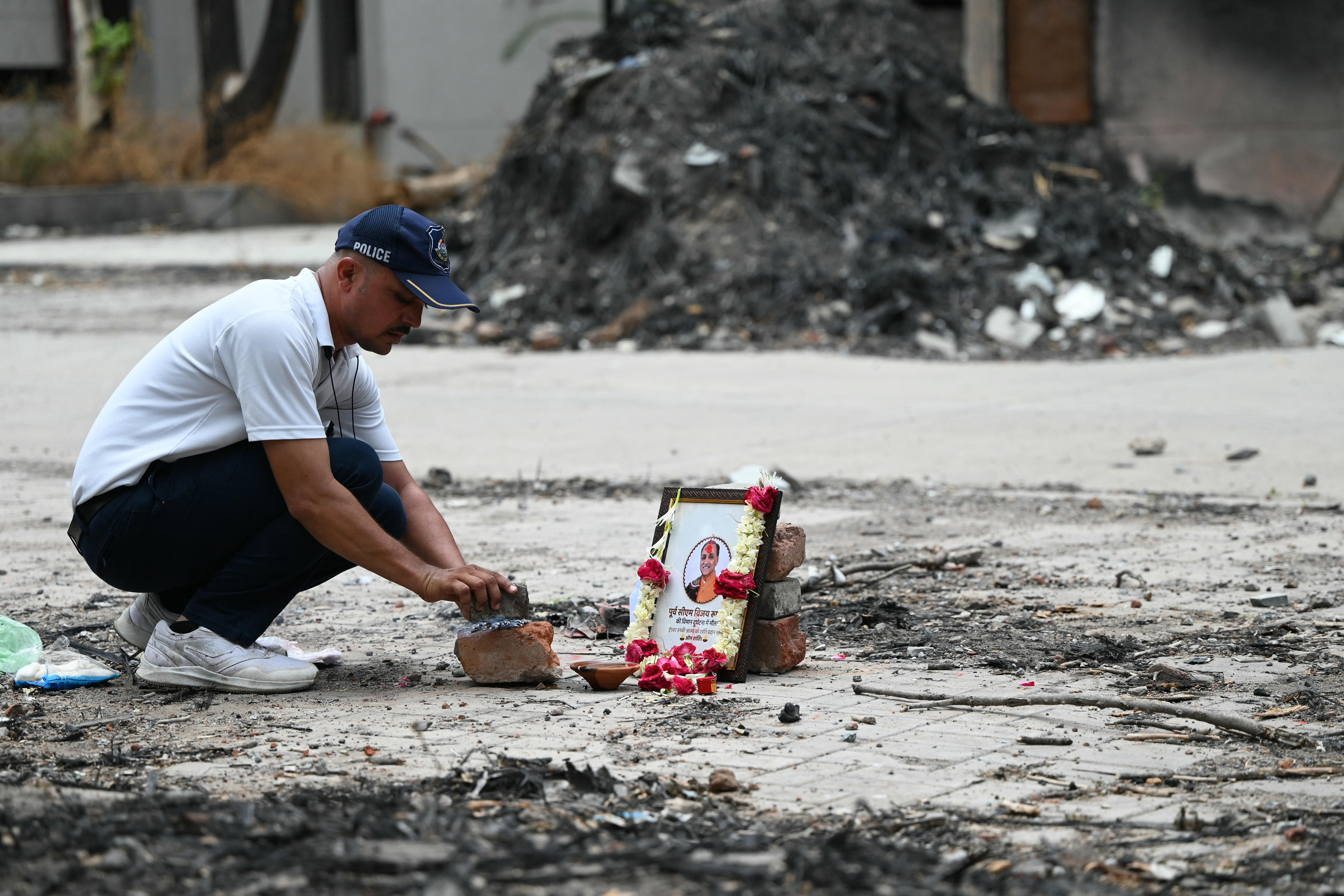 A tribute is set up for Air India Flight 171 plane crash victim Vijay Rupani, former Gujarat chief minister, at the crash site on the first anniversary of the disaster in Ahmedabad on June 12, 2026.