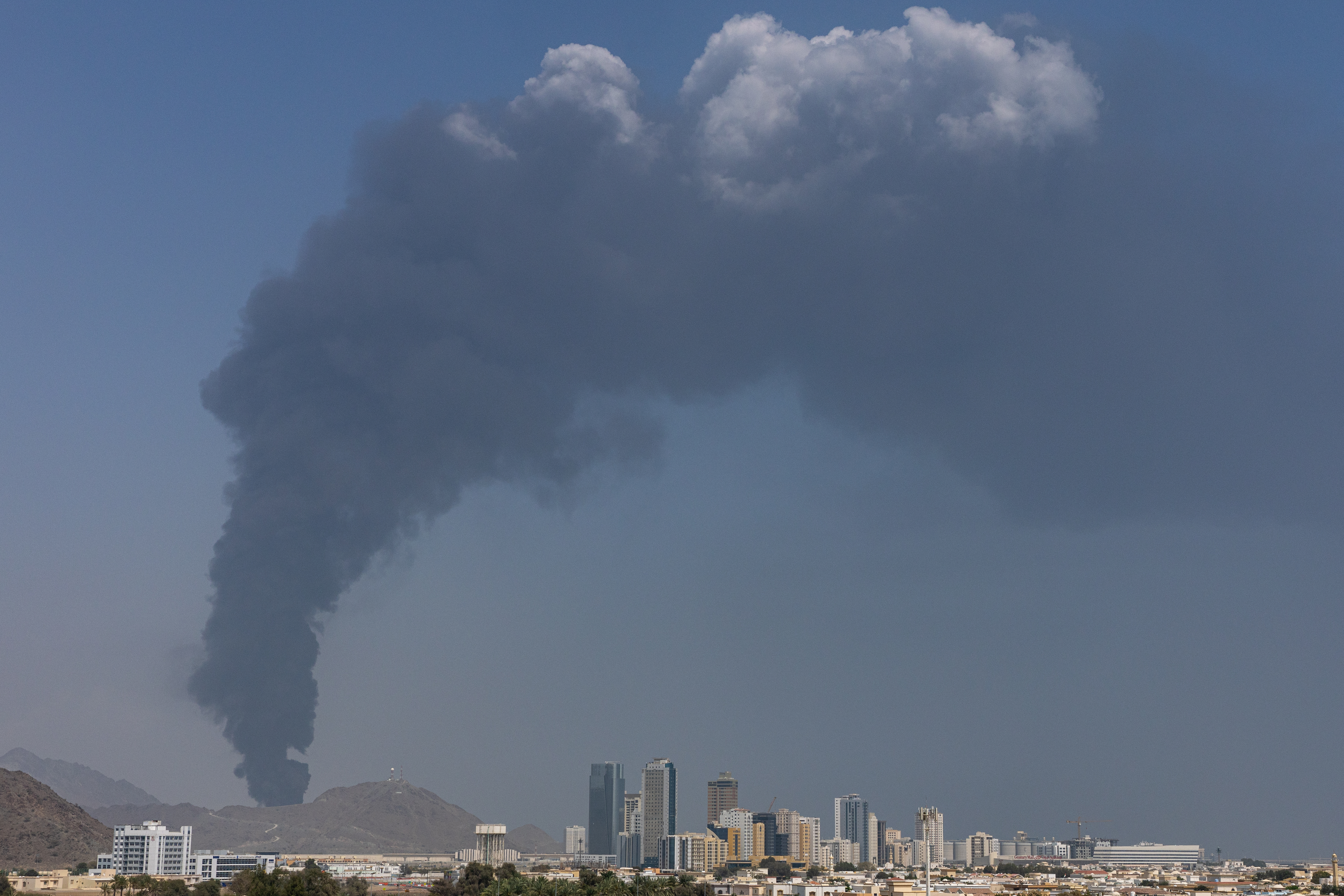 FUJAIRAH, UNITED ARAB EMIRATES - MARCH 05: Smoke rises after an explosion in the industrial zone, caused by debris after interception of a drone by air defence, according to the Fujairah media office on March 05, 2026, in Fujairah, United Arab Emirates. In recent days, Iran has fired drones and missiles toward the UAE and other Gulf states, following the joint U.S.-Israeli attack on Iran that began on February 28. Foreign ministers from the Gulf Co-operation Council (GCC) held an online meeting on March 1 and issued a statement saying they will take "all necessary measures" to defend their security and territory, condemning Iran's attacks as "heinous." (Photo by Christopher Pike/Getty Images)