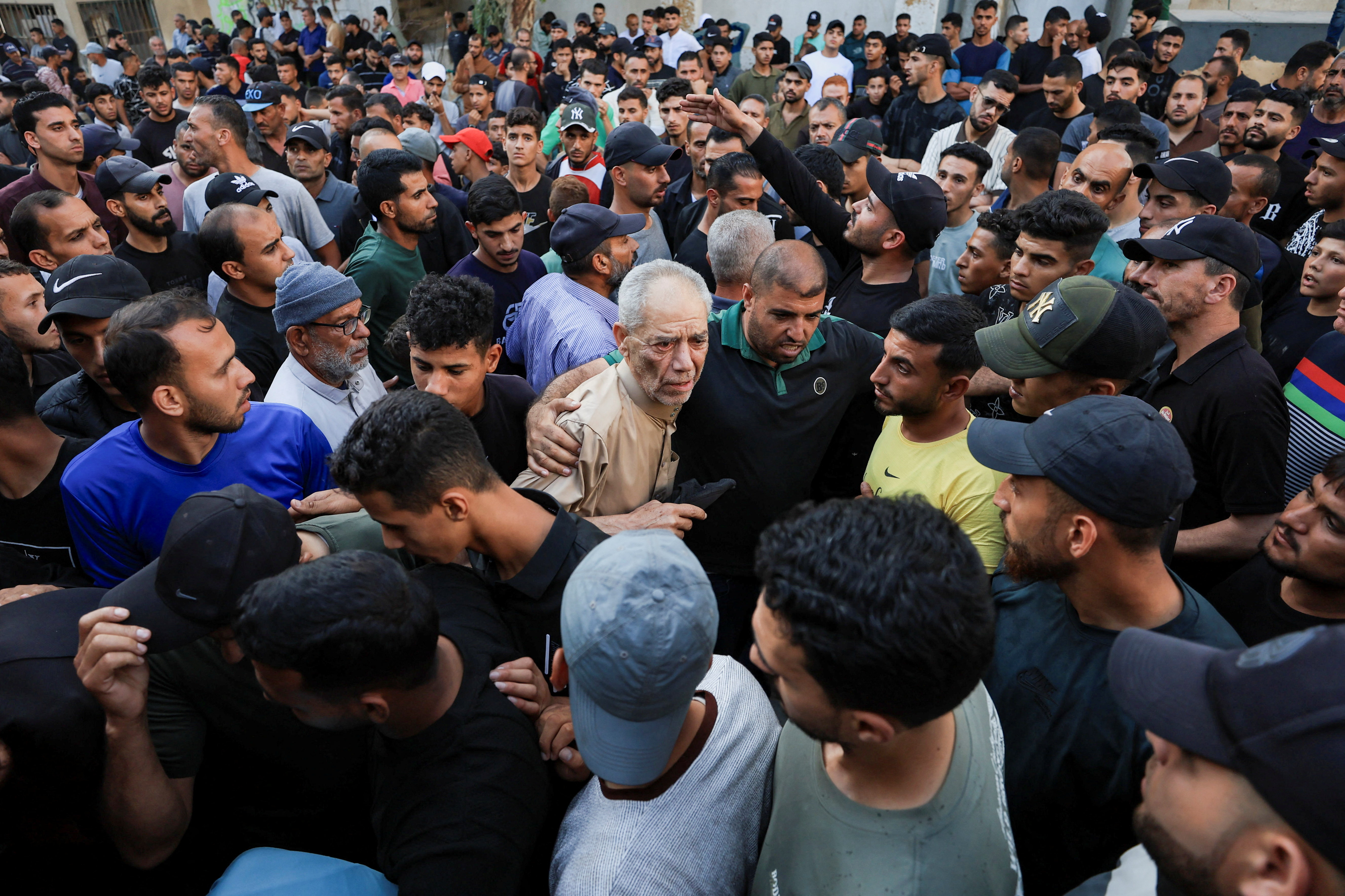 Palestinians react following an Israeli strike on a tent encampment in Gaza City