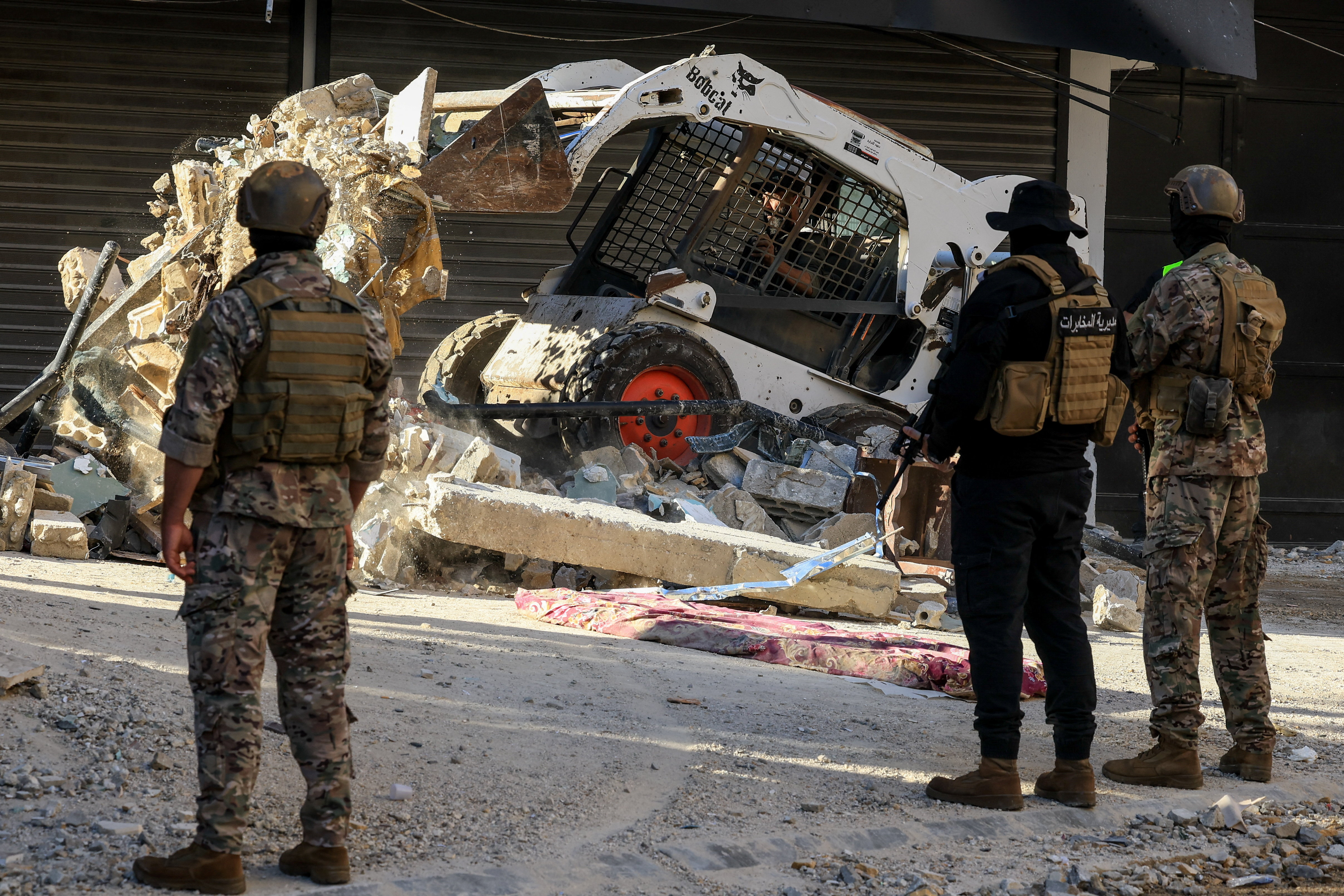 Heavy machinery operates to remove the rubble in the aftermath of an attack.