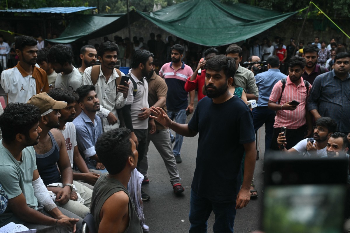 Cockroach Janta Party (CJP) founder Abhijeet Dipke speaks to victims who were injured during a protest demanding the resignation of India’s Education Minister Dharmendra Pradhan over alleged NEET exam irregularities, in New Delhi on July 21, 2026