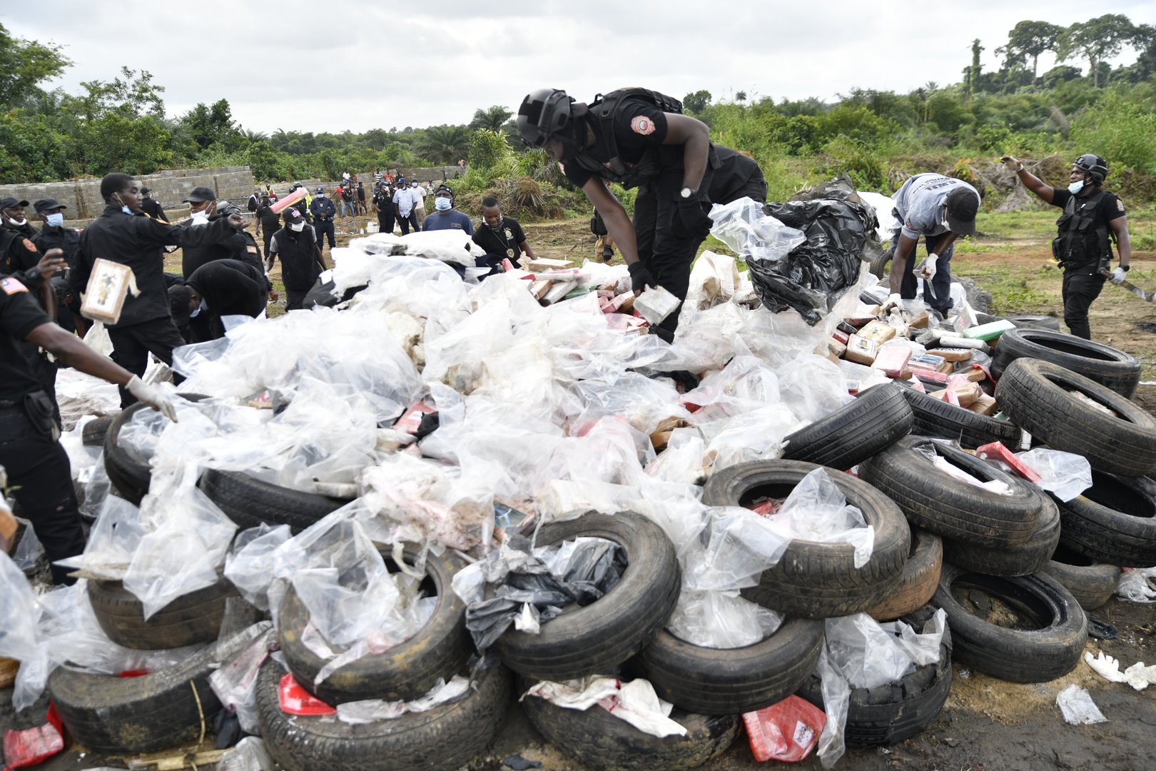 Liberian law enforcement agency officials prepare to burn cocaine consignments in Caraysburg in the outskirts of Monrovia, Liberia, Thursday, July 30, 2026. [AP Photo/Alexander Wiaplah]