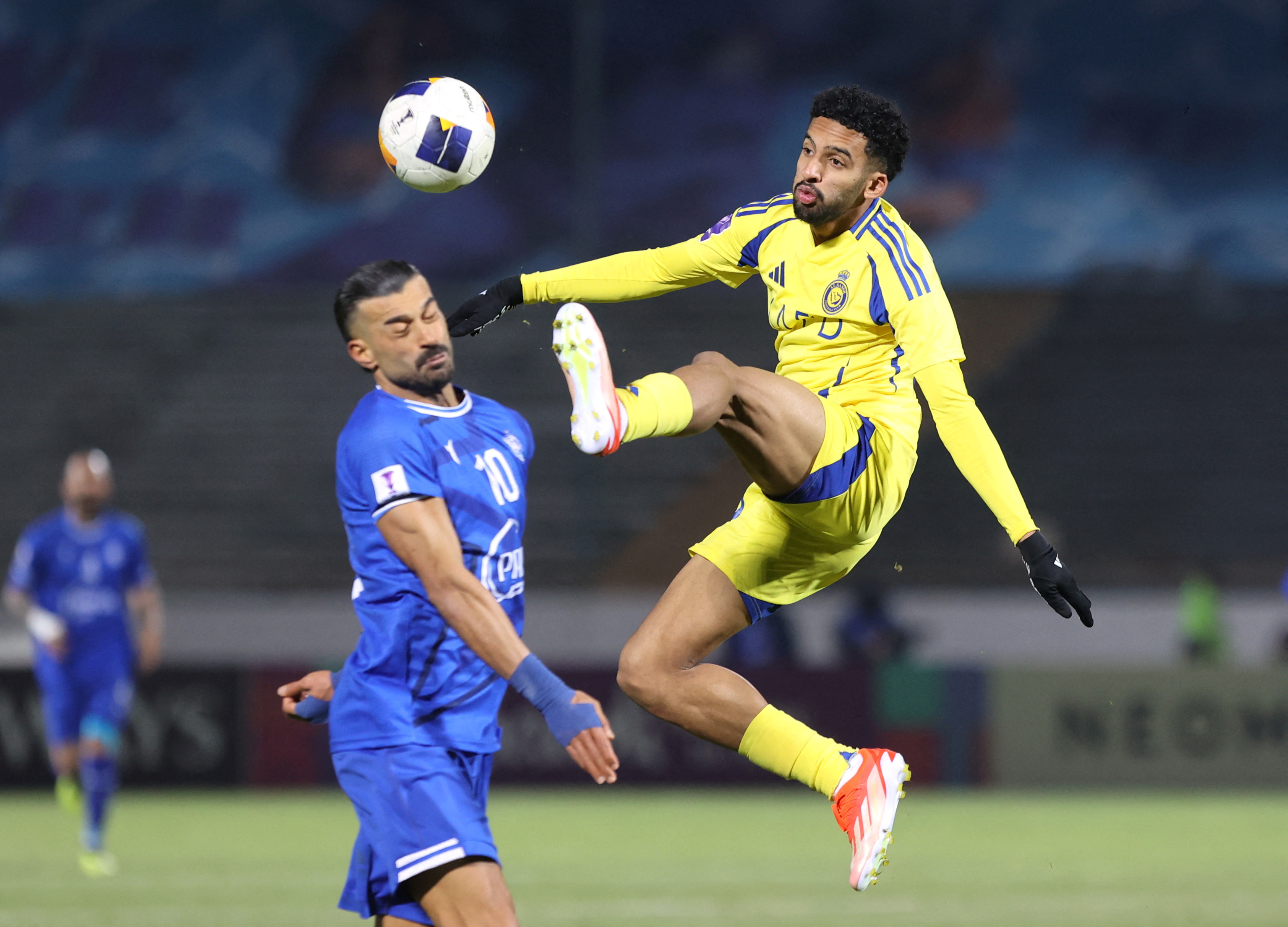 Al Nassr's Salem Al Najdi in action with Esteghlal's Ramin Rezaeian